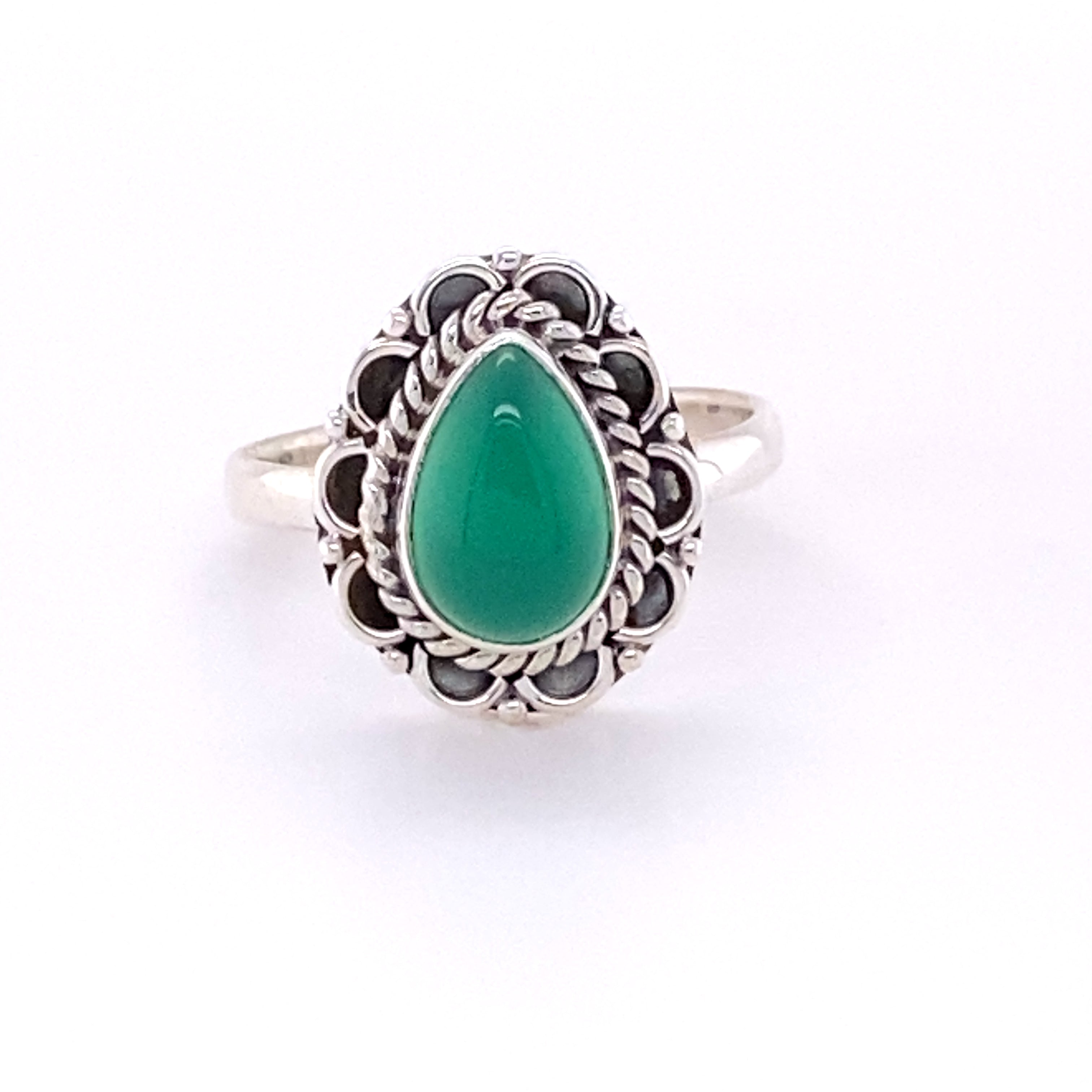 A Teardrop Gemstone Ring with Flower Filigree Border with a green jade cabochon stone.