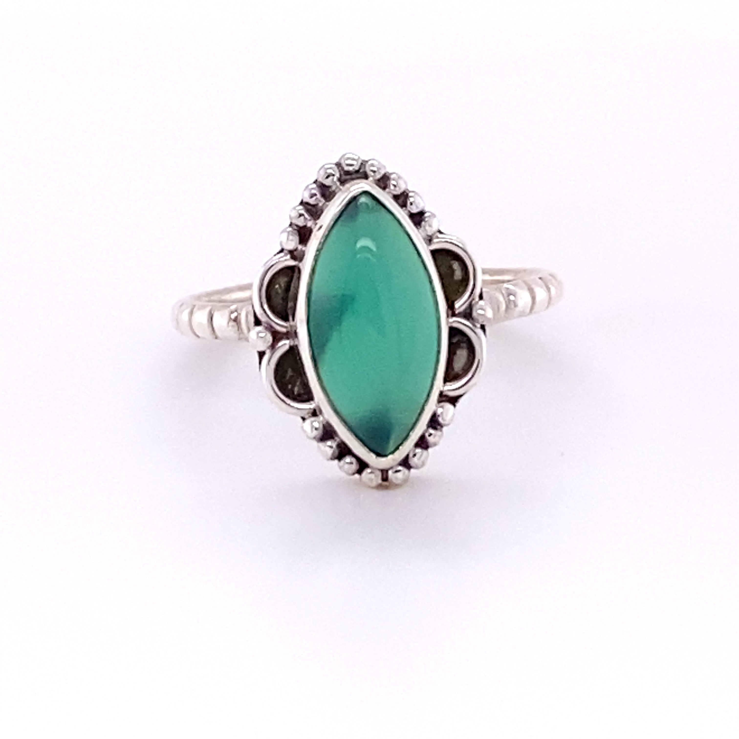 A Marquise Shaped Gemstone Ring with Ball Border and Textured Band with a green stone.