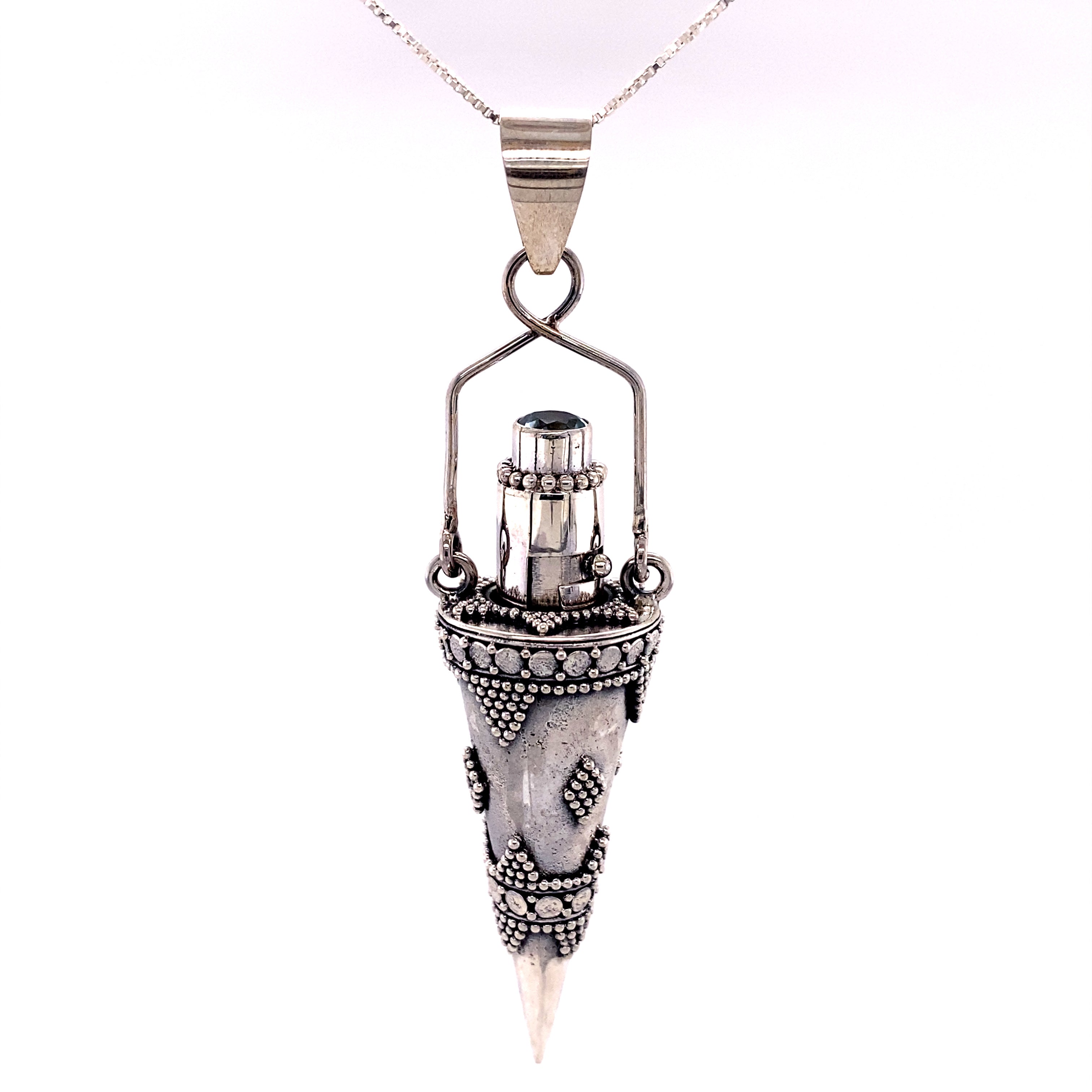 An Ornate Stone Poison Pendant with a Super Silver cone on it.