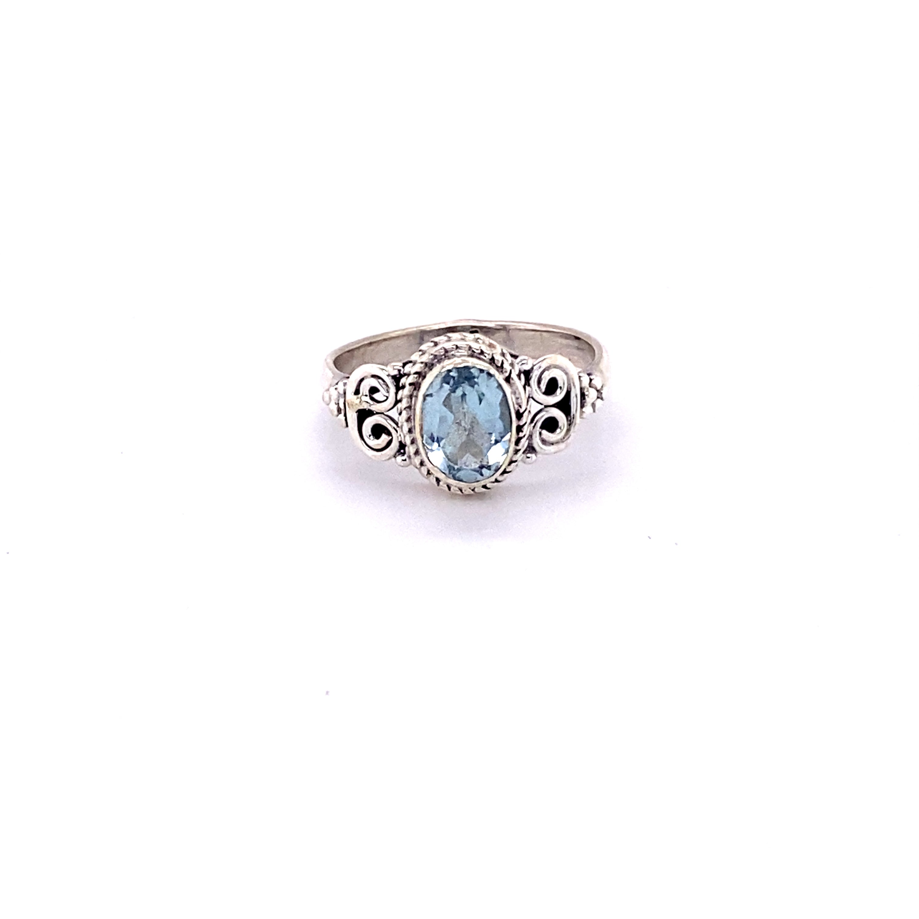 A sterling silver Oval Faceted Gemstone Ring with a Swirl Design, perfect for adding a touch of boho style.