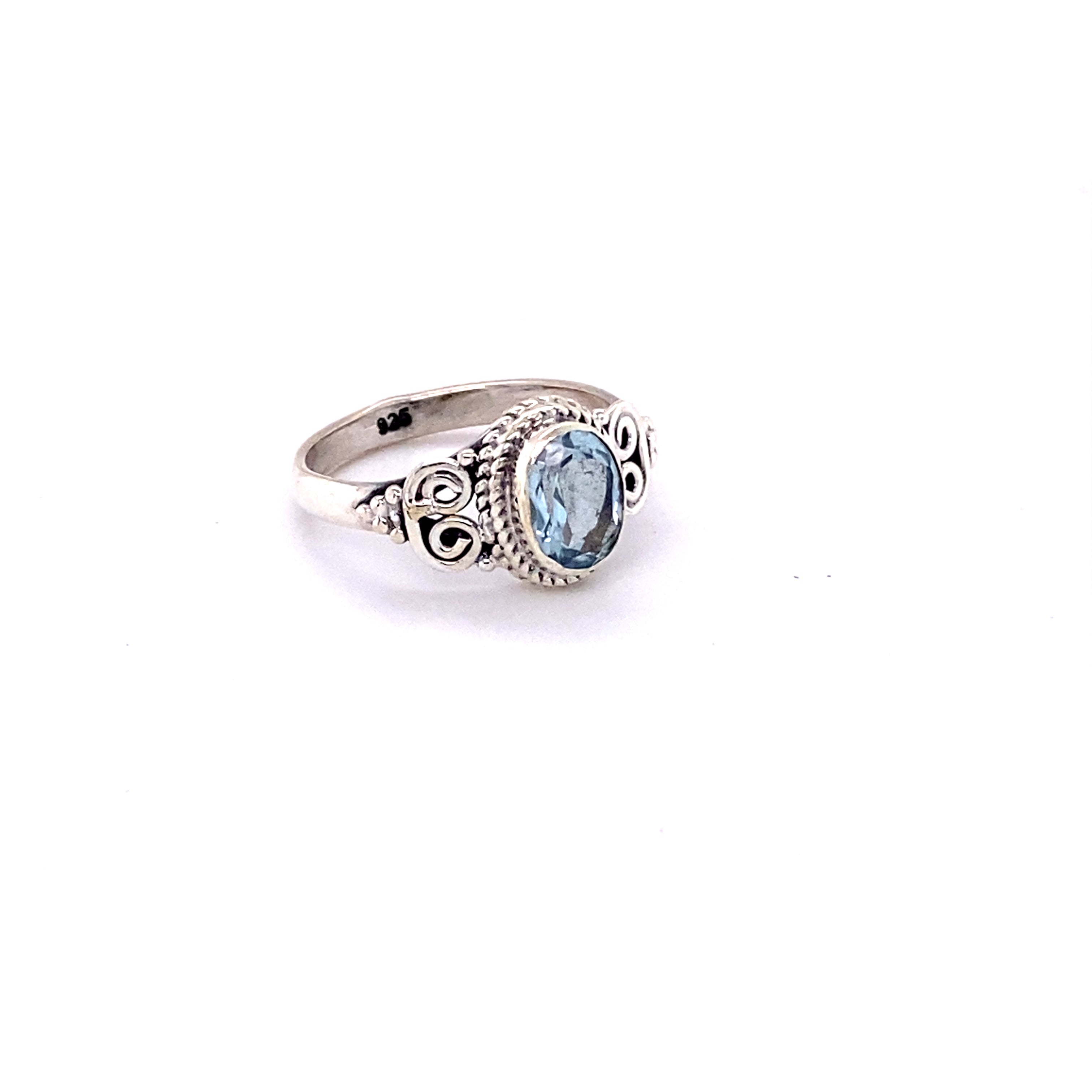 A boho-inspired Oval Faceted Gemstone Ring with a Swirl Design.