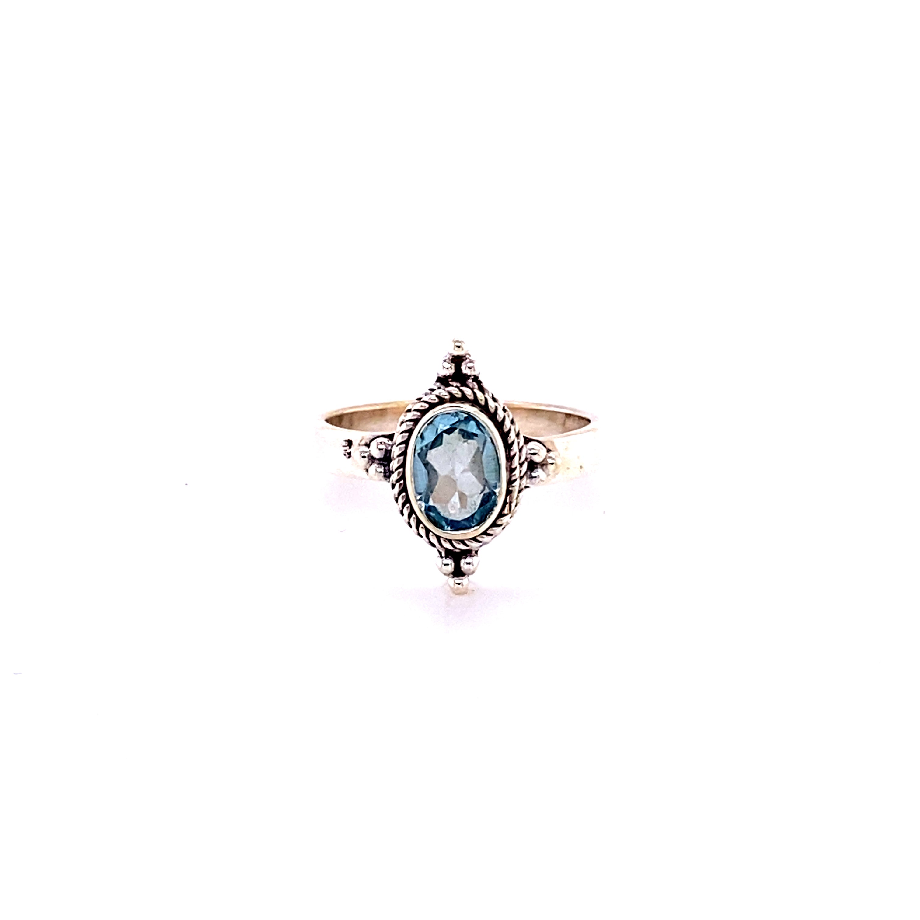 A Four Points Gemstone Ring with an oval blue topaz stone.