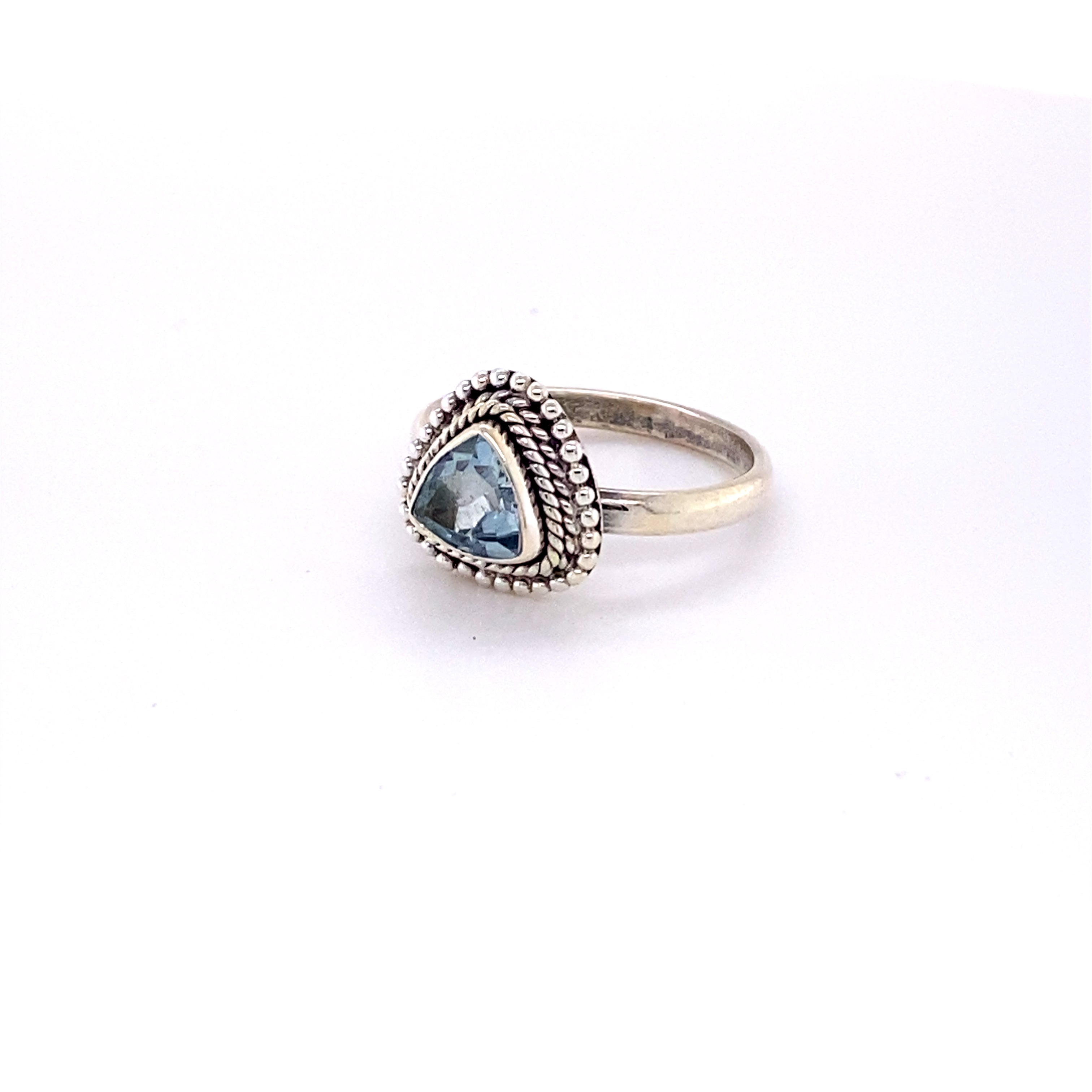 A Super Silver Triangle Gemstone Ring with Rope Border with a blue topaz stone.