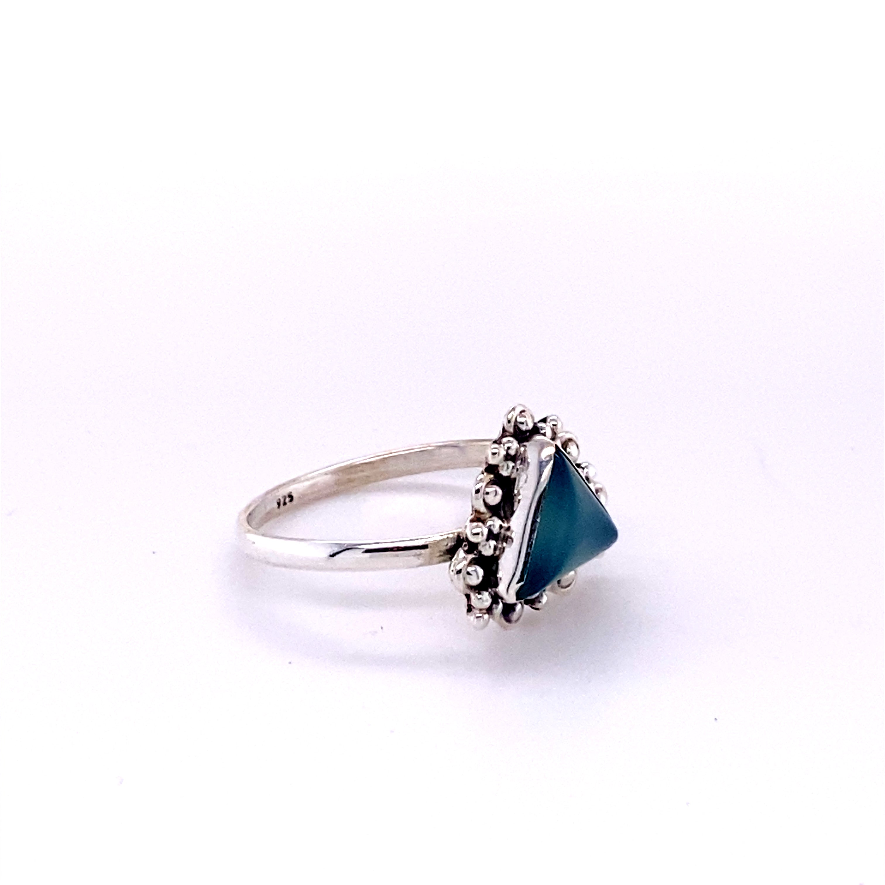 A Delicate Gemstone Triangle Ring with a cabochon stone in the middle.