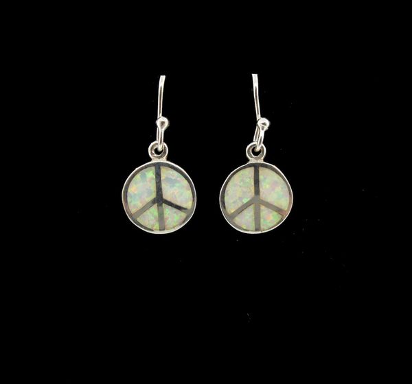 A pair of Super Silver White Created Opal Round Peace Sign Earrings on a black background.