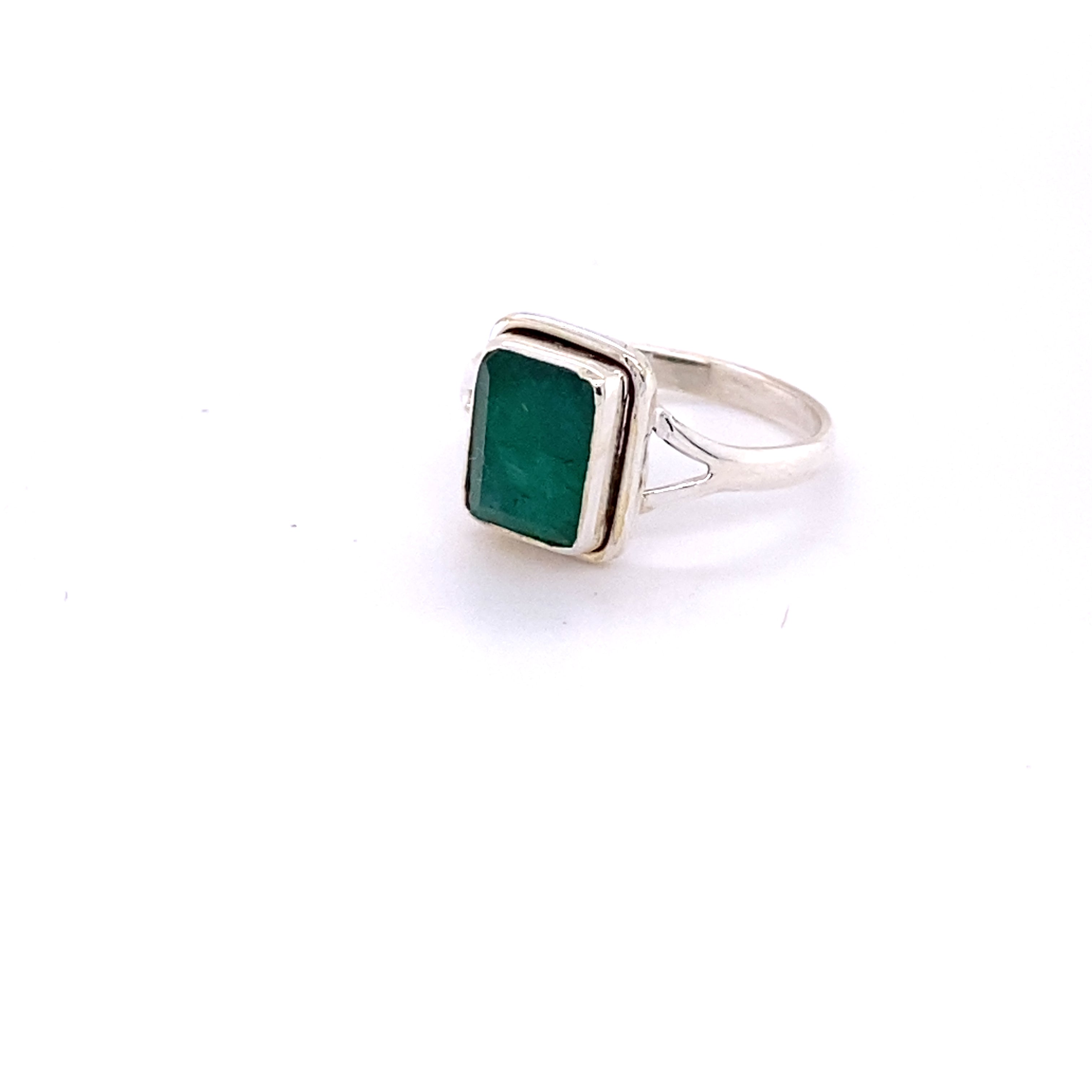A simple square gemstone ring on a white background.