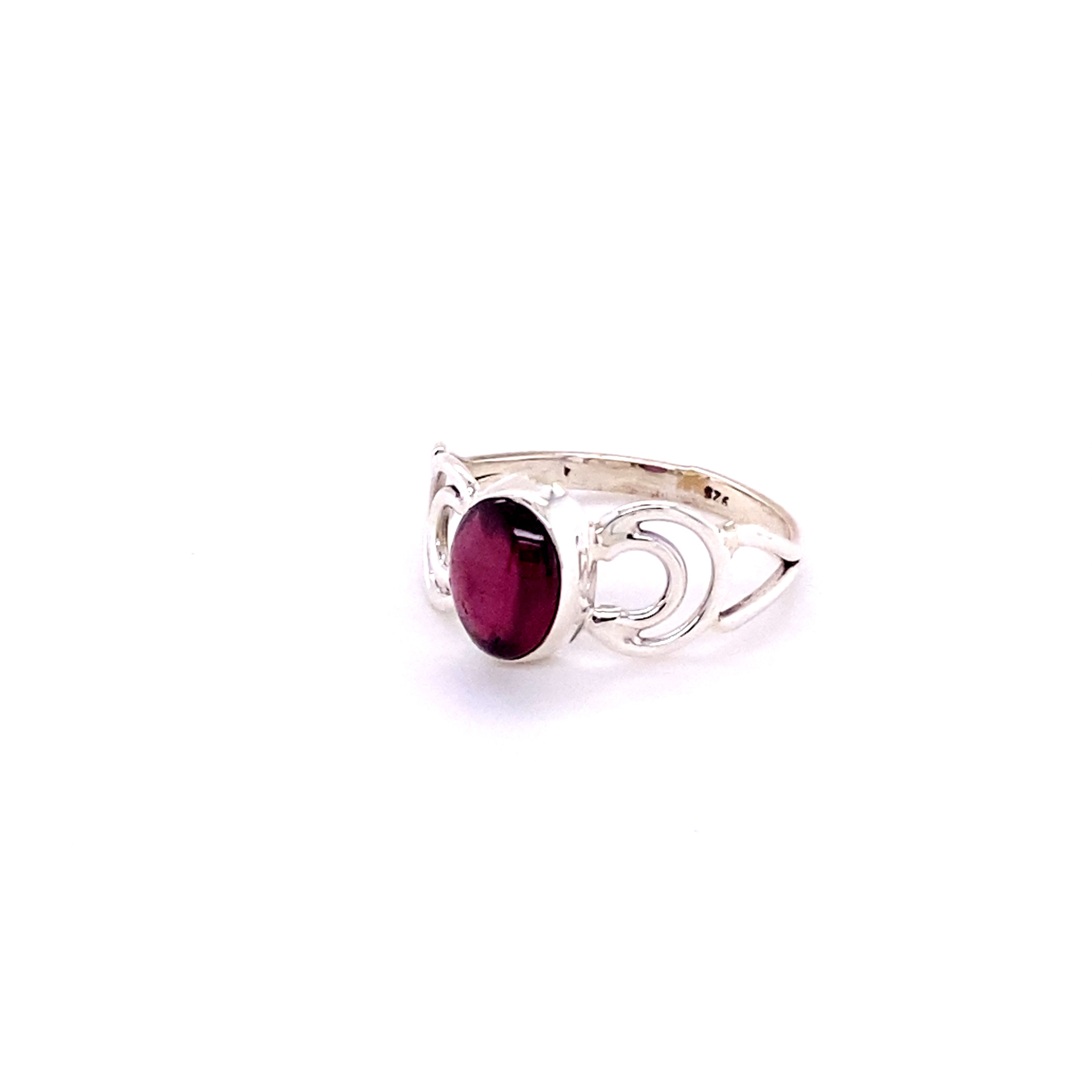 An oval gemstone ring with moon design featuring a vibrant ruby stone.