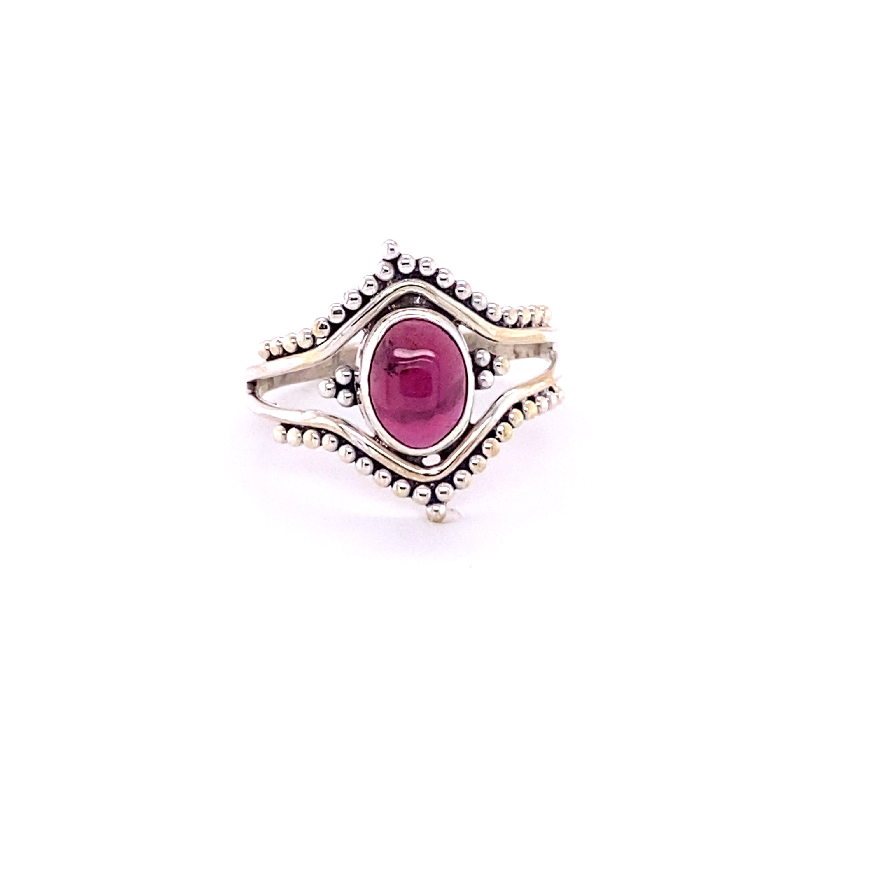 A Double Chevron Gemstone Ring with Ball Design with a ruby cabochon stone in the center.