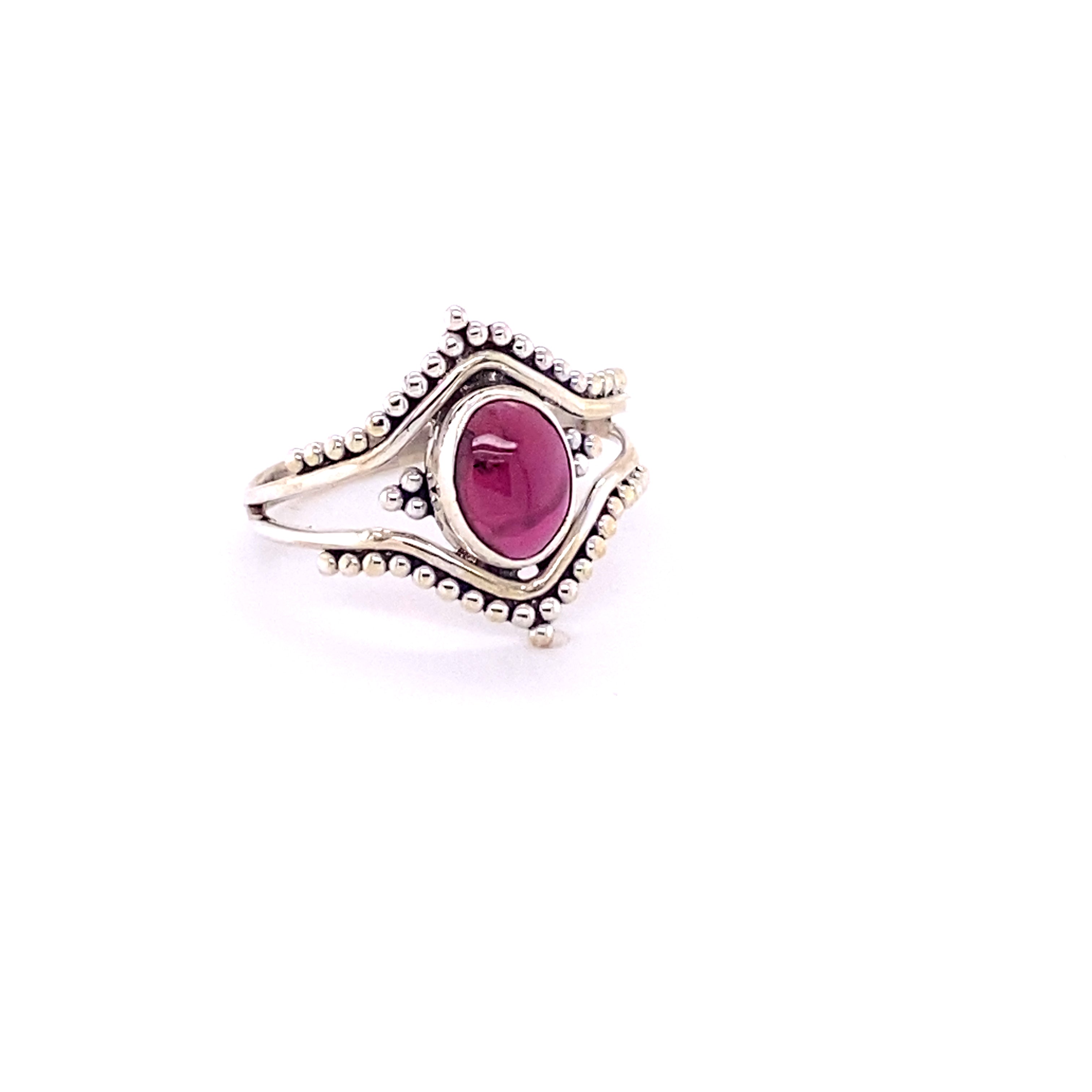 A Double Chevron Gemstone Ring with Ball Design with a ruby stone.