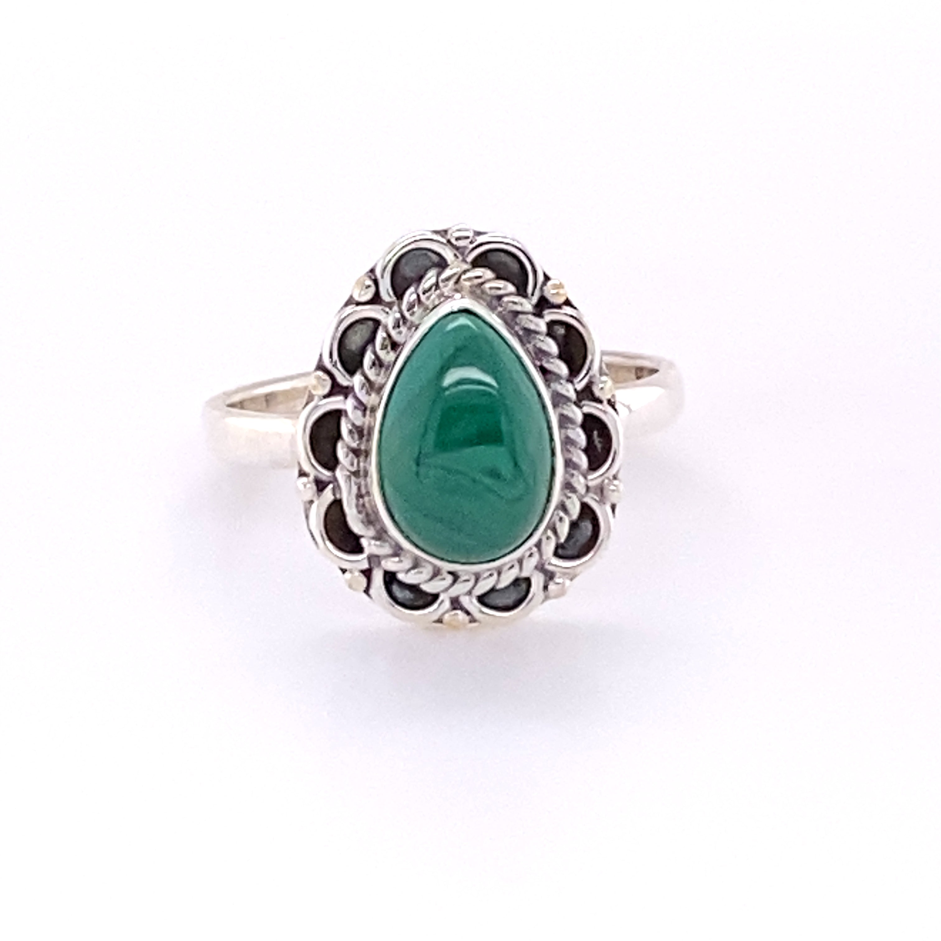 A Teardrop Gemstone Ring with Flower Filigree Border with a cabochon green stone and black stones.