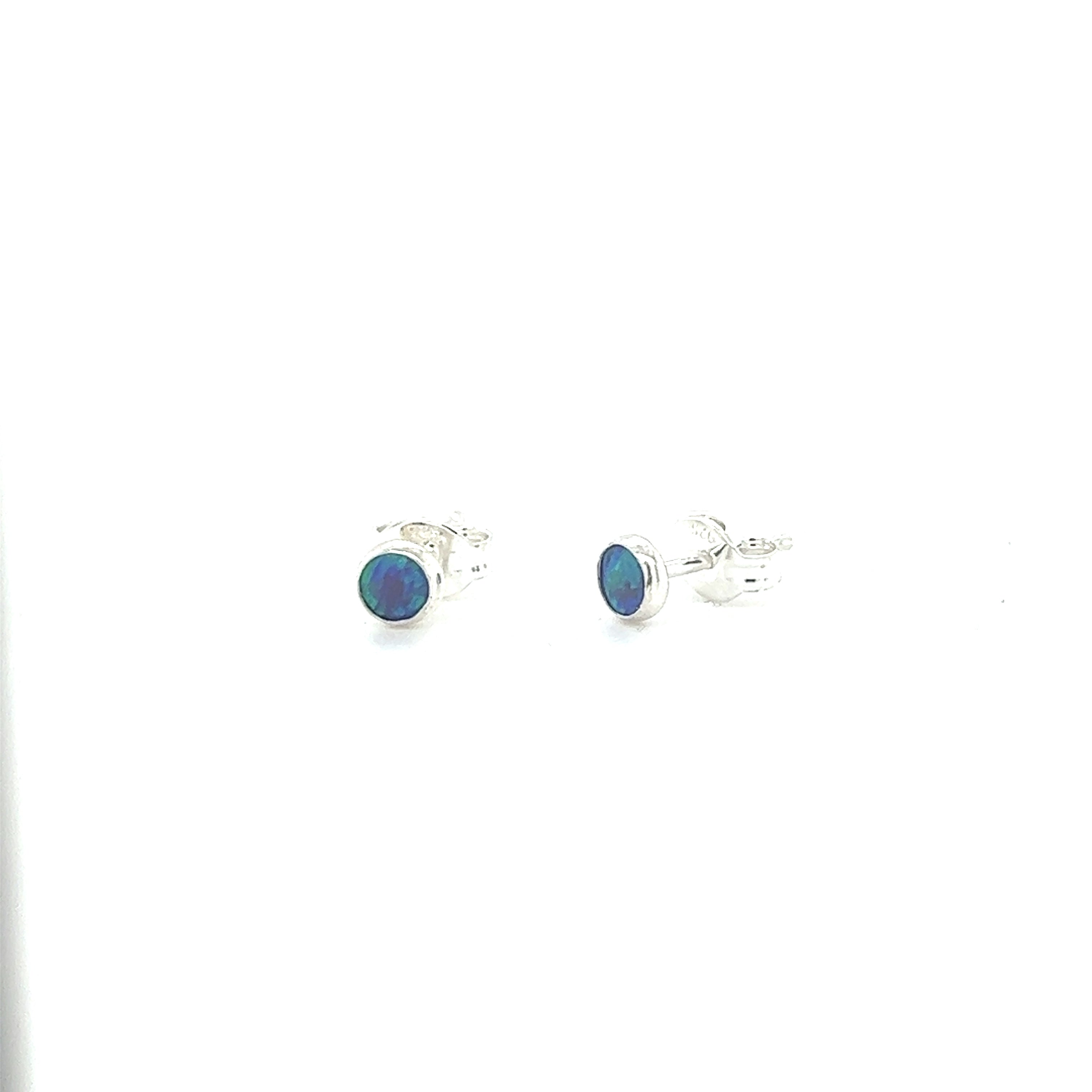 A pair of Super Silver Dainty Opal Studs, made with sterling silver, displayed on a white background.