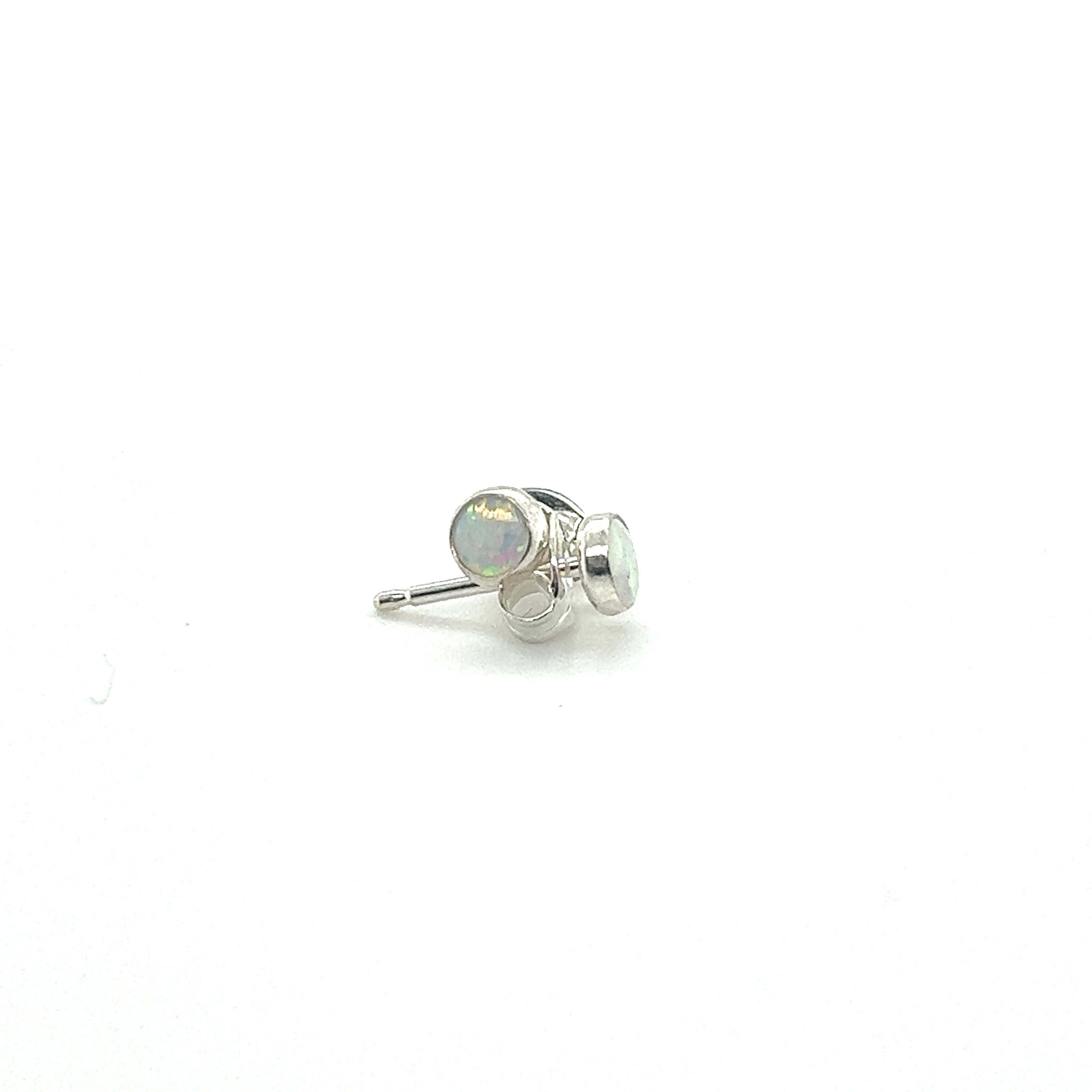 A pair of Super Silver Dainty Opal Studs, made of sterling silver, showcased on a white surface.