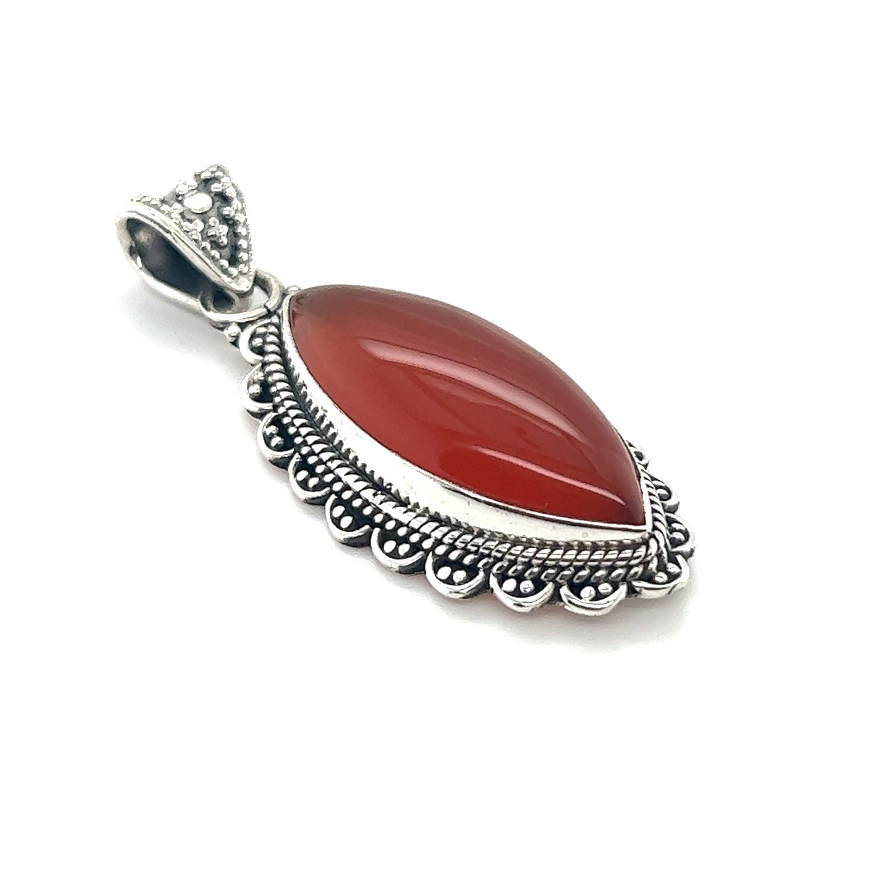 A Marquise Shaped Gemstone Pendant adorned with a vibrant red carnelian stone, crafted delicately from Super Silver.