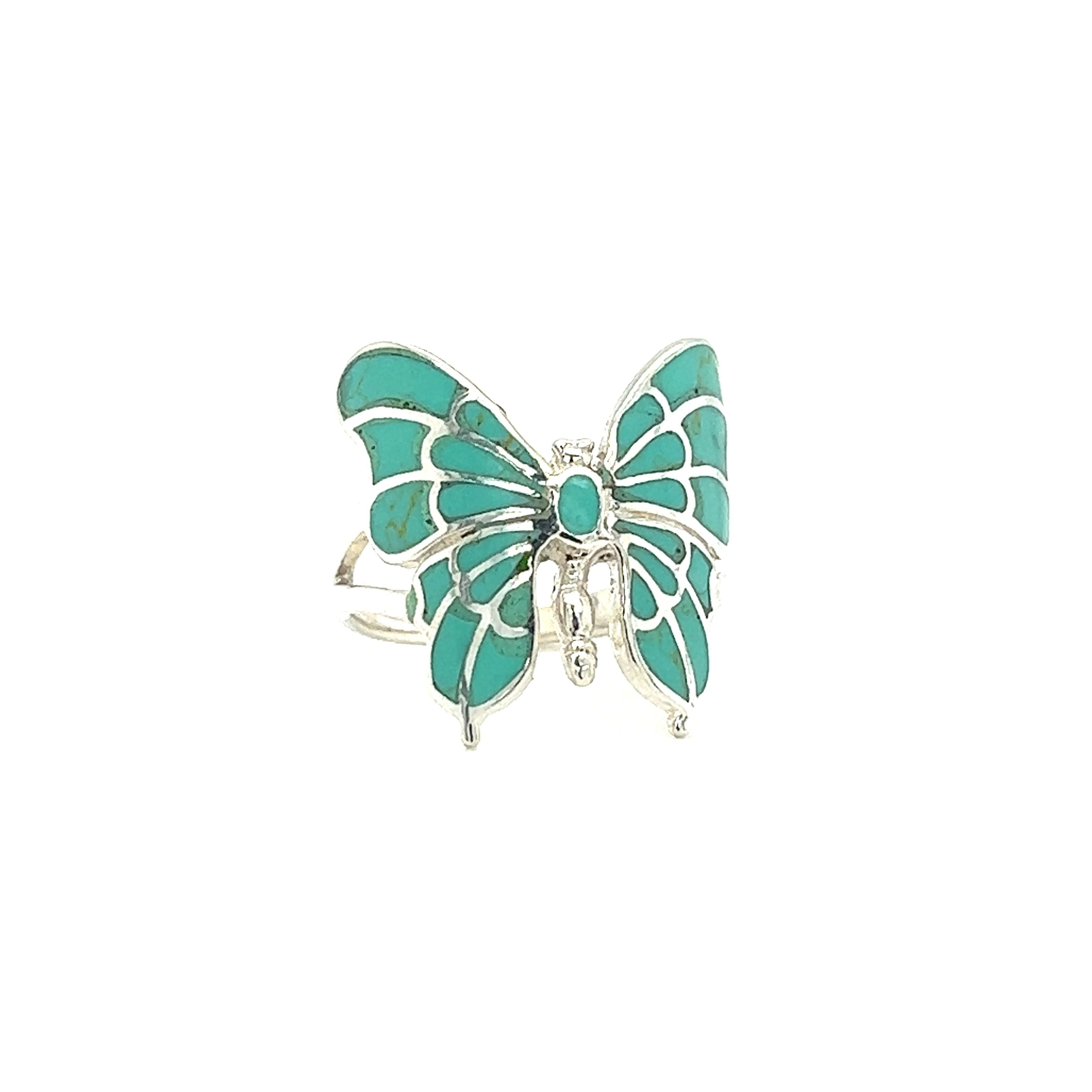A turquoise Intricate Statement Butterfly Inlay ring on a white background.