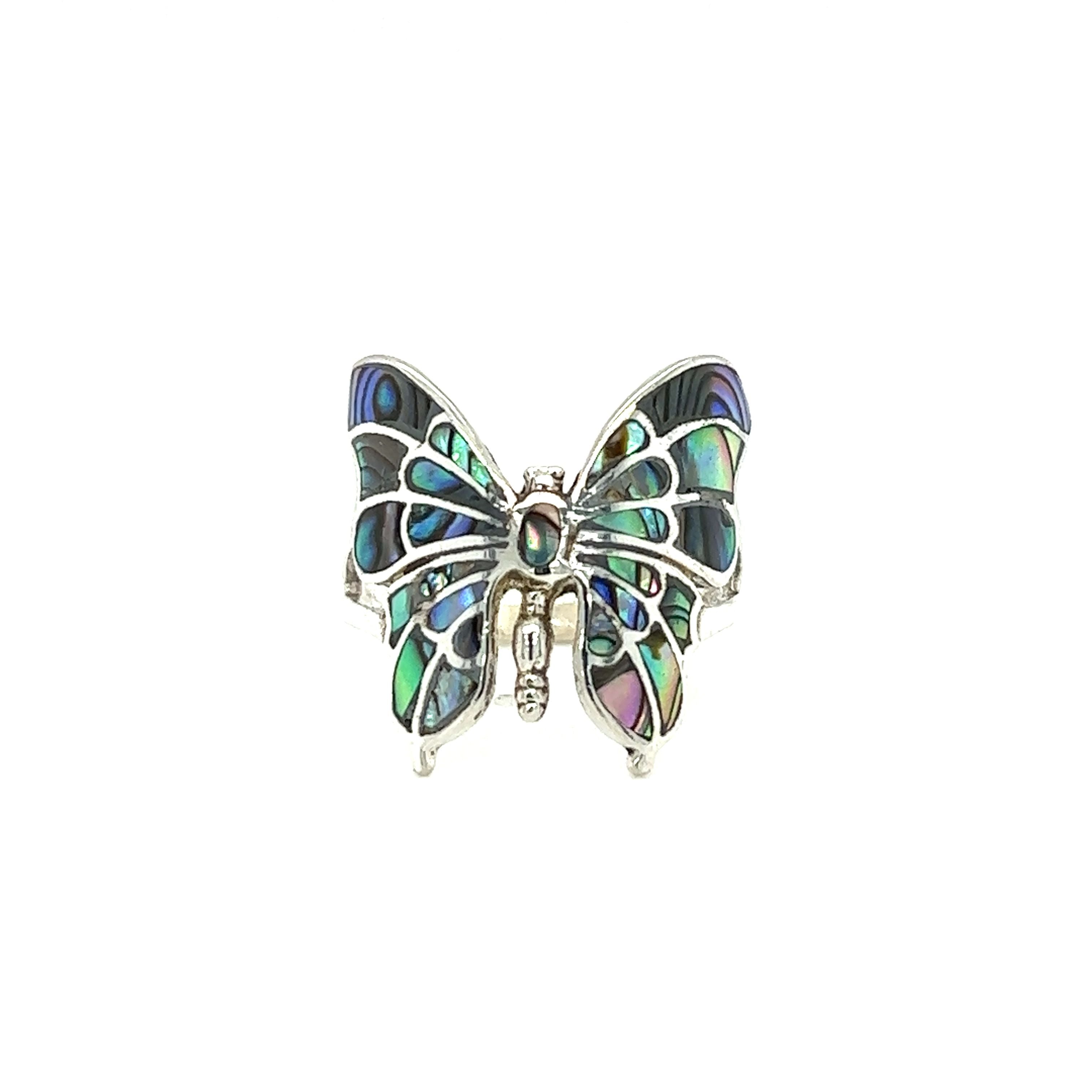 An intricate statement butterfly inlay ring on a white background.