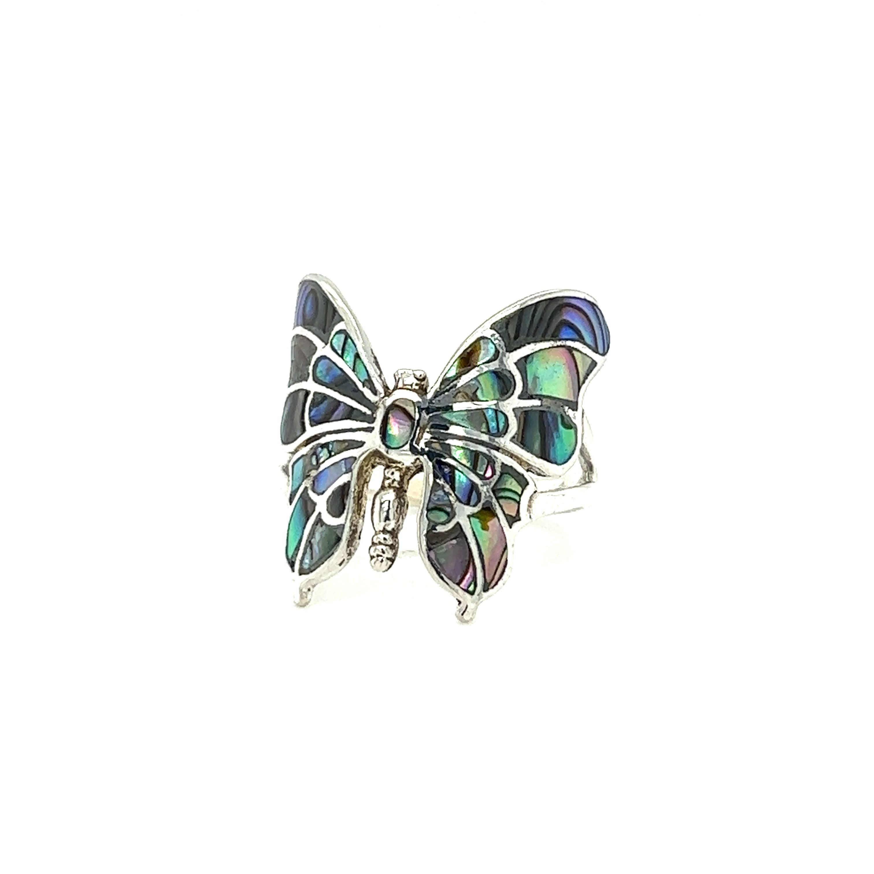 An intricate statement butterfly inlay ring with inlay on a white background.