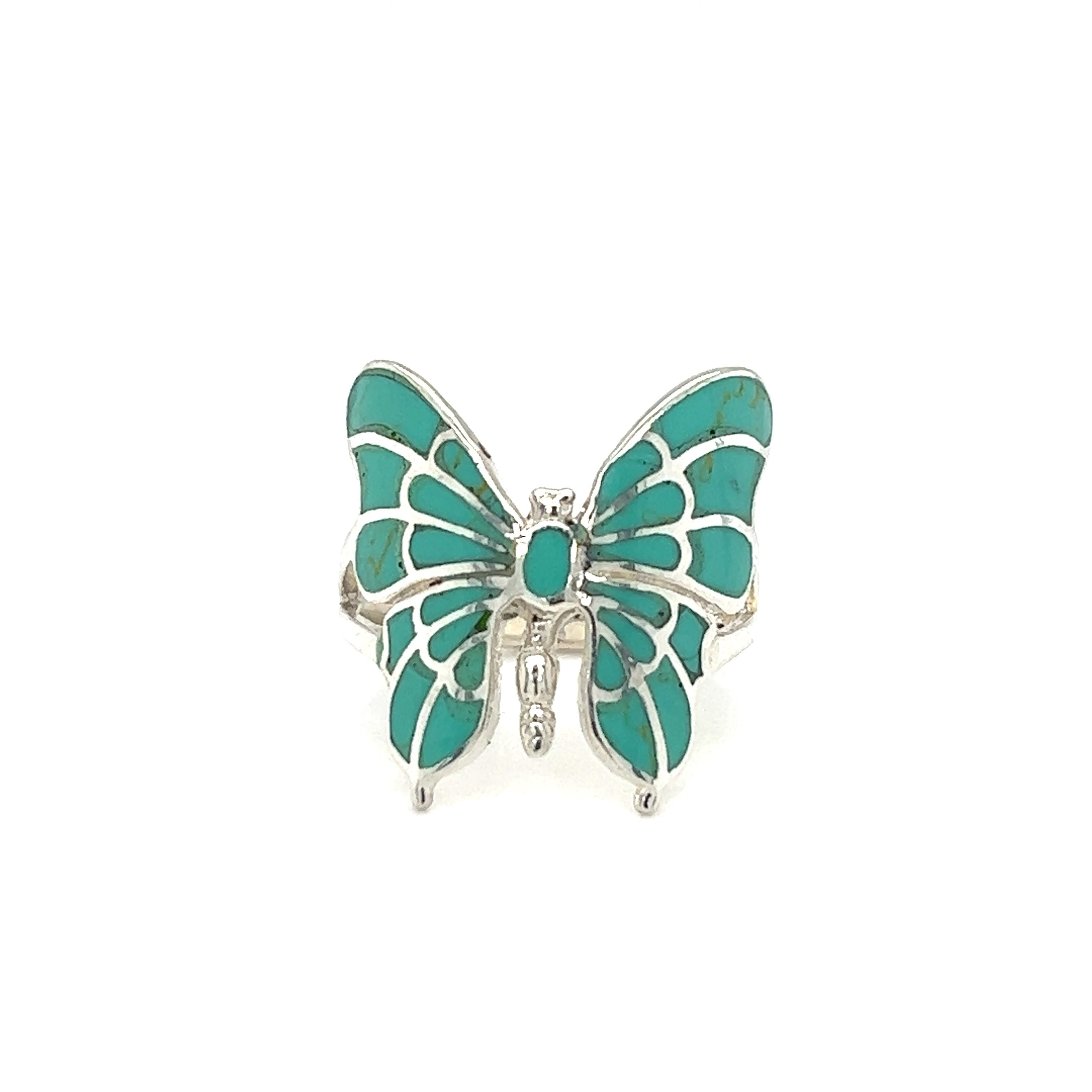 Make a statement with this stunning Intricate Statement Butterfly Inlay Ring featuring turquoise and white stone inlay.
