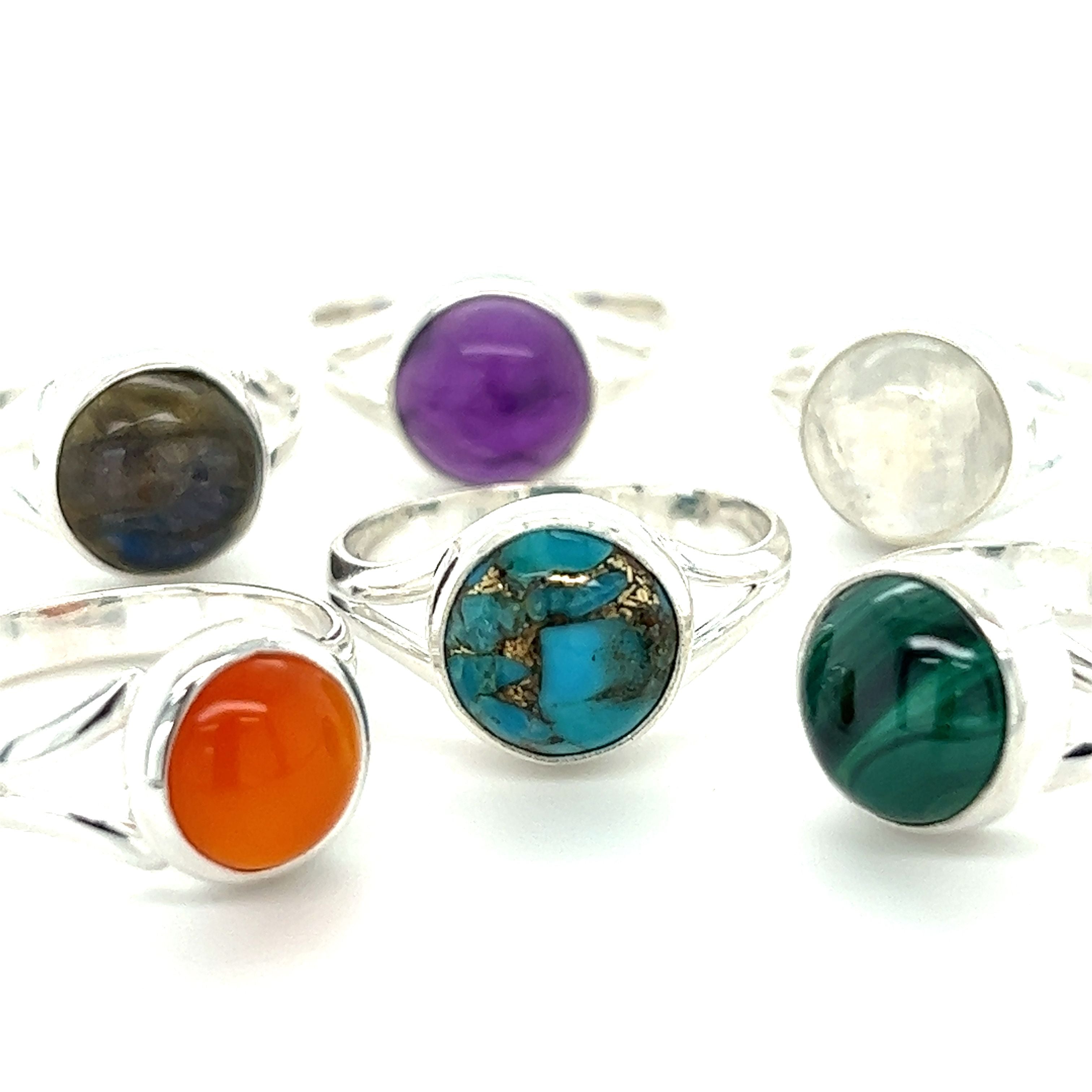 A set of Simple Vibrant Circular Stone Rings by Super Silver with vibrant stones in different colors.