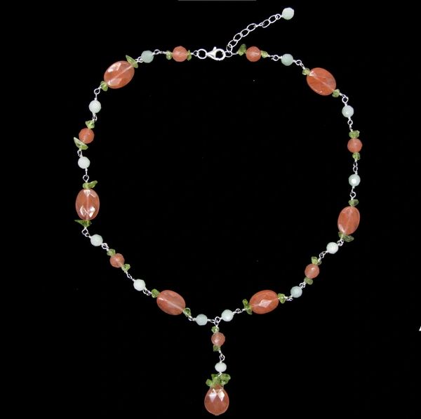 
                  
                    A Beaded Multicolor Y-necklace with coral beads and pearls on a black background, by Super Silver.
                  
                