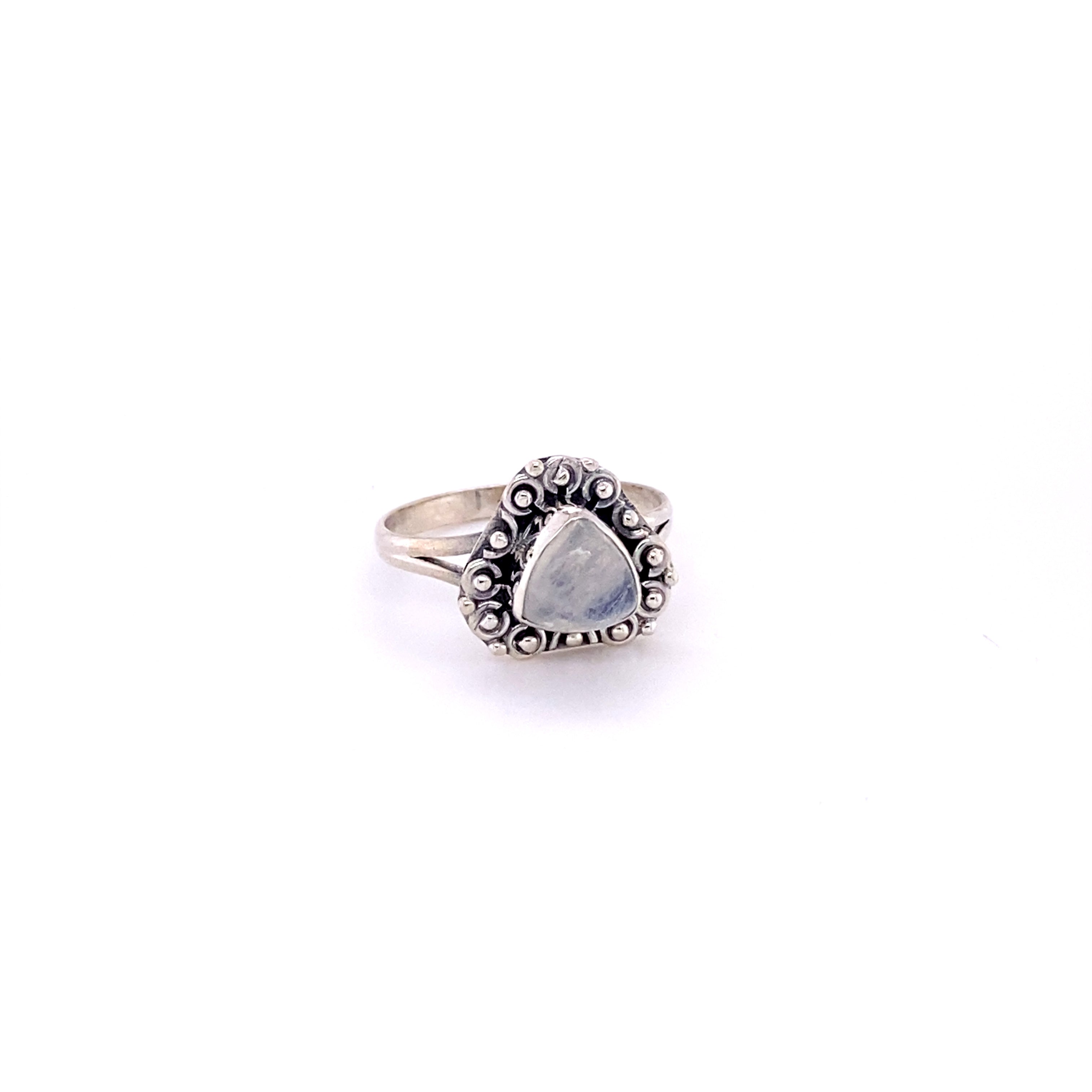 A triangular gemstone ring with a flat ball boarder and a white stone in the middle.