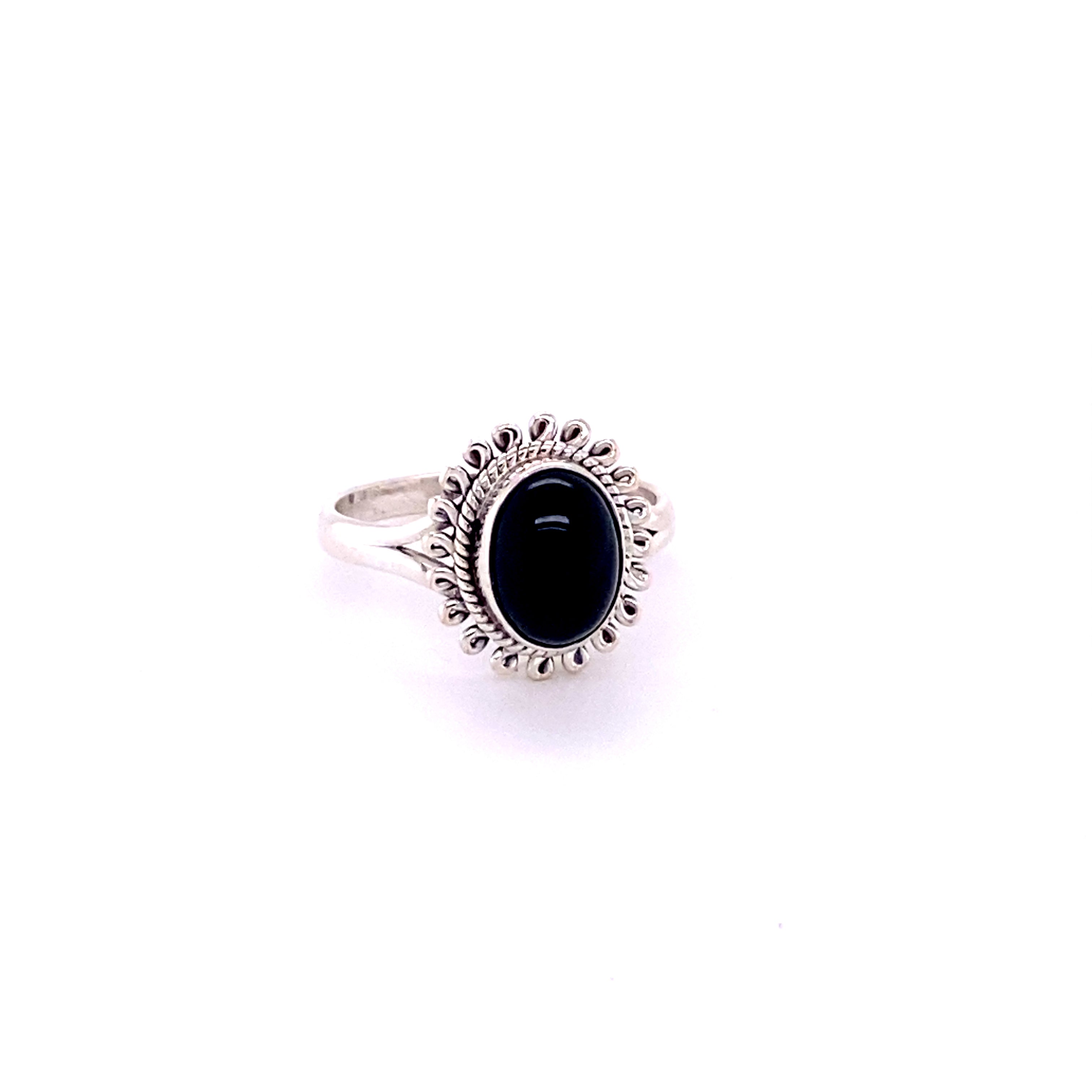 A Hippie-Chic Oval Gemstone Flower Ring with a black cabochon stone in the center.