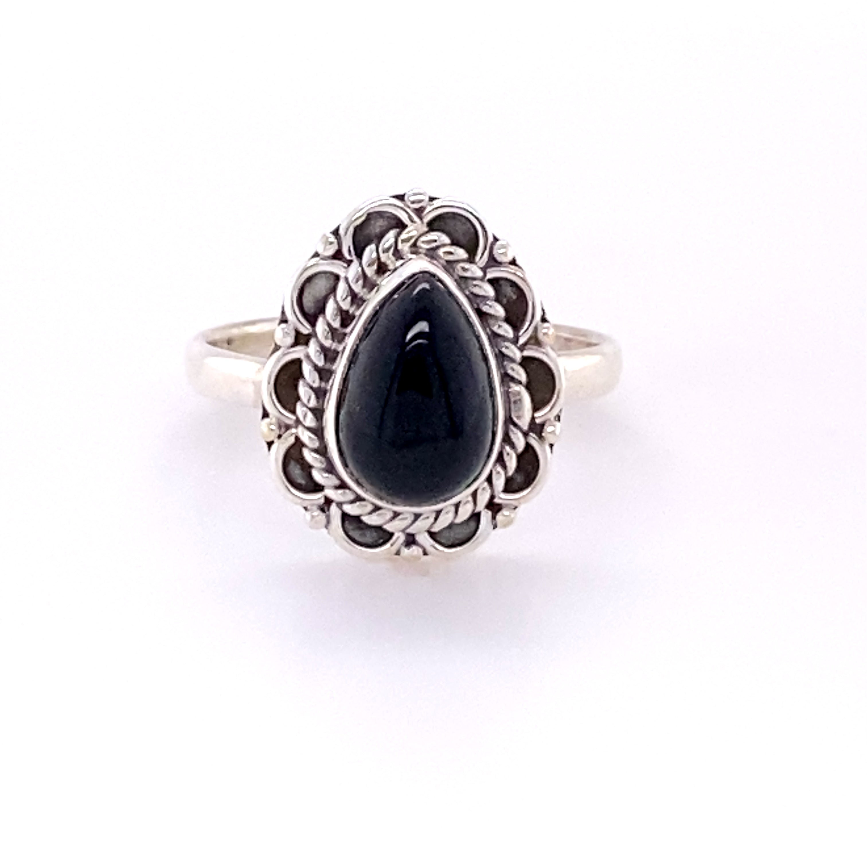 A Teardrop Gemstone Ring with Flower Filigree Border featuring a cabochon black onyx stone.