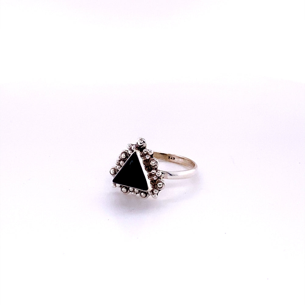 
                  
                    A Delicate Gemstone Triangle Ring by Super Silver with a black triangle on it.
                  
                