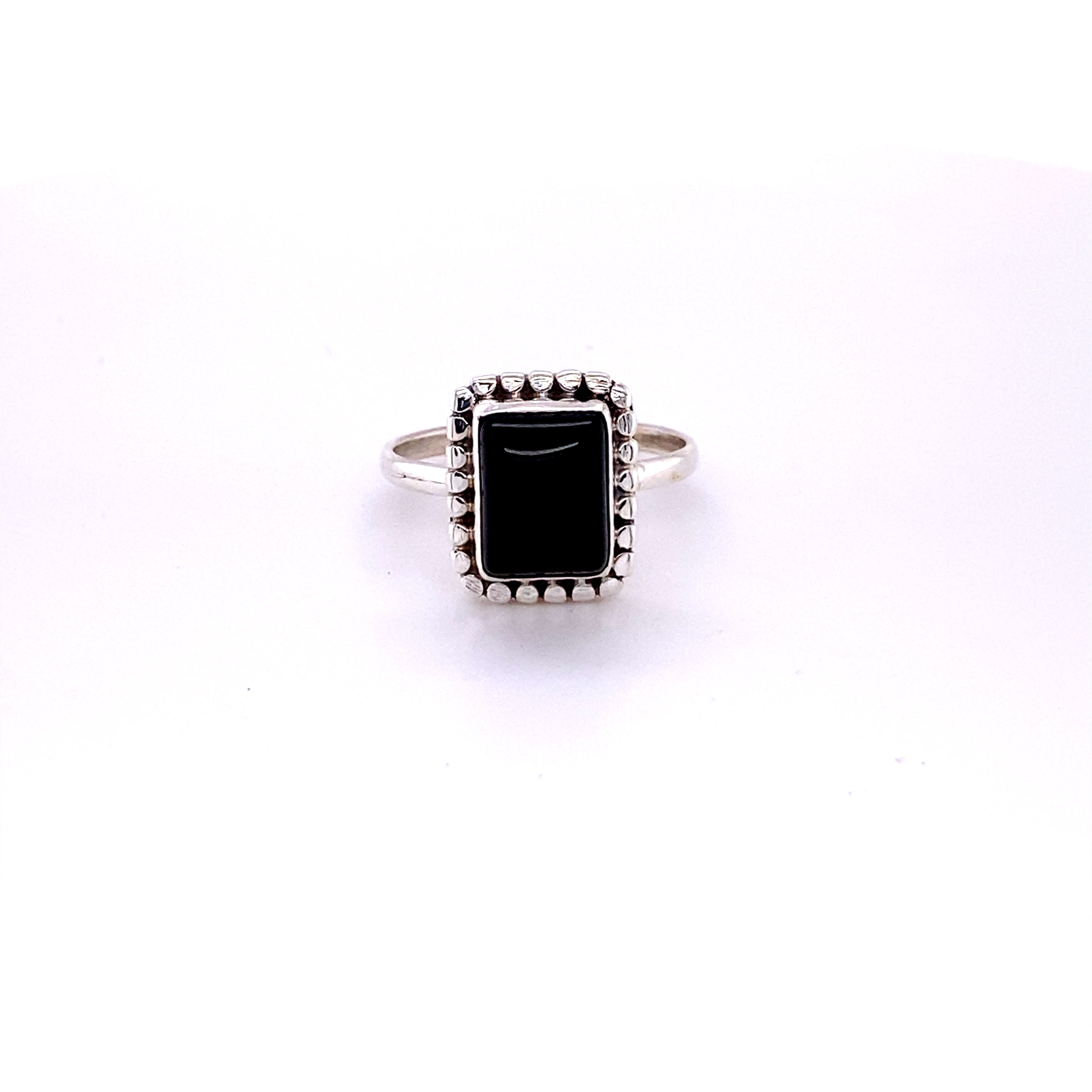 A square ring with natural gemstones on a white background.