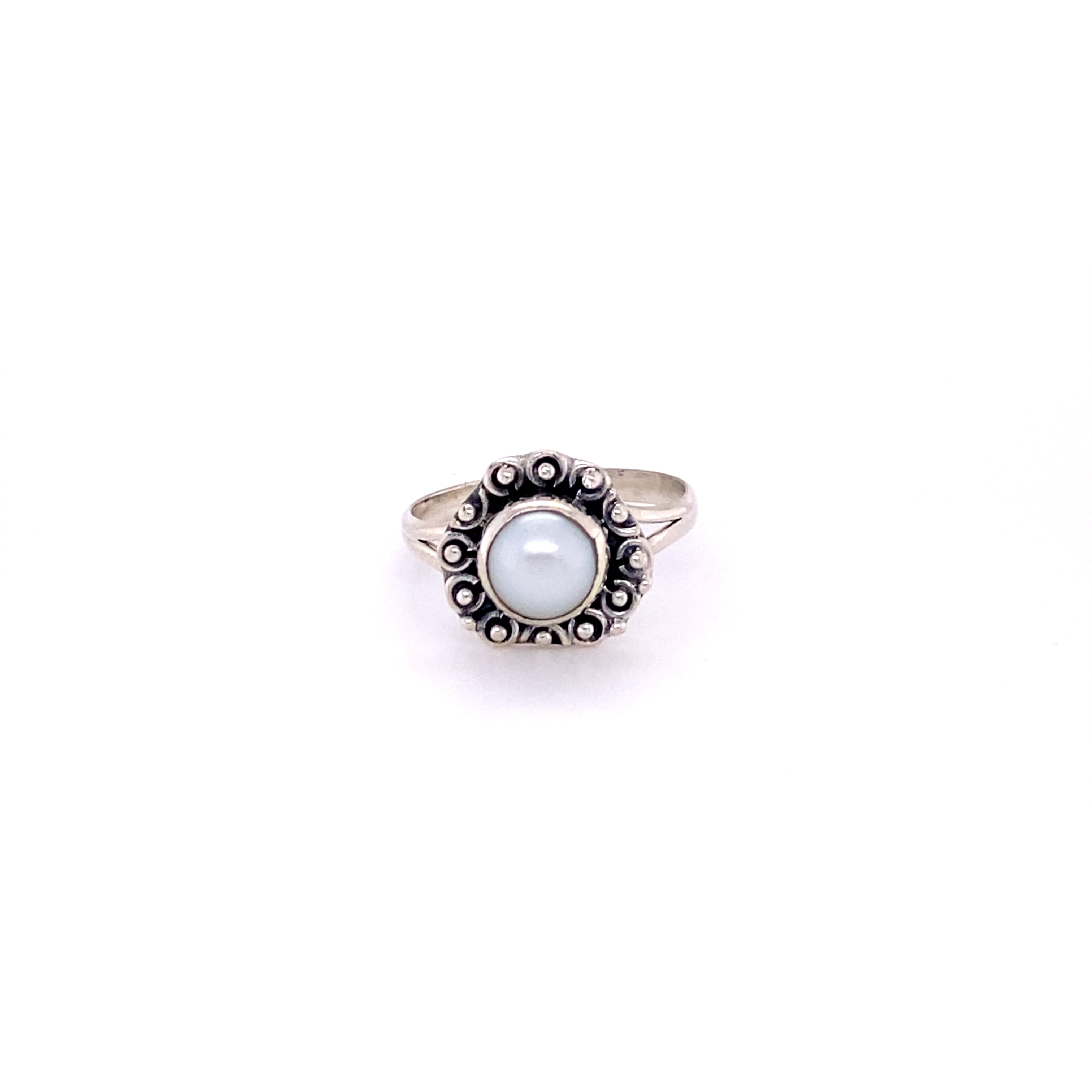 A triangular gemstone ring with a flat ball border and a blue cabochon stone in the center.
