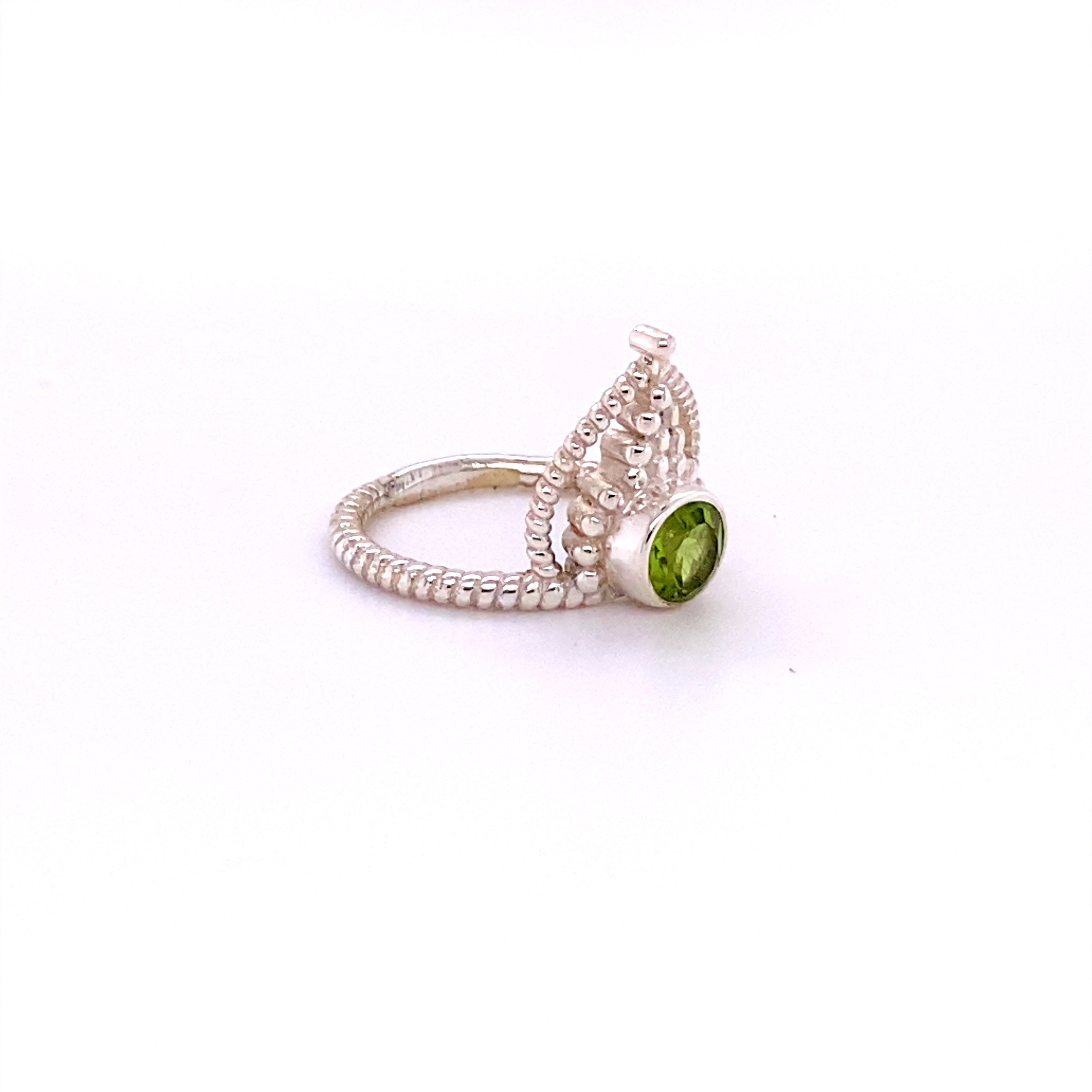 A Simple Tiara Ring with Natural Gemstones by Super Silver, with a peridot nestled amidst a henna design.
