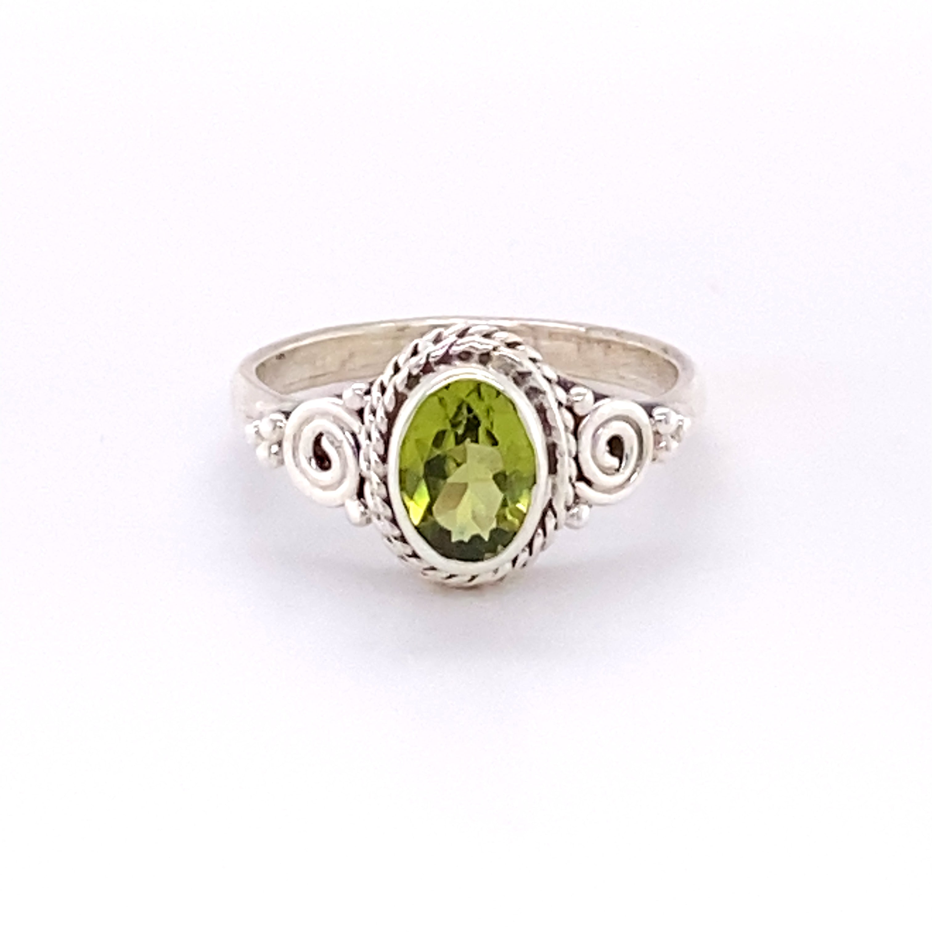A Super Silver Oval Peridot Ring with Intricate Rope and Spiral Border.