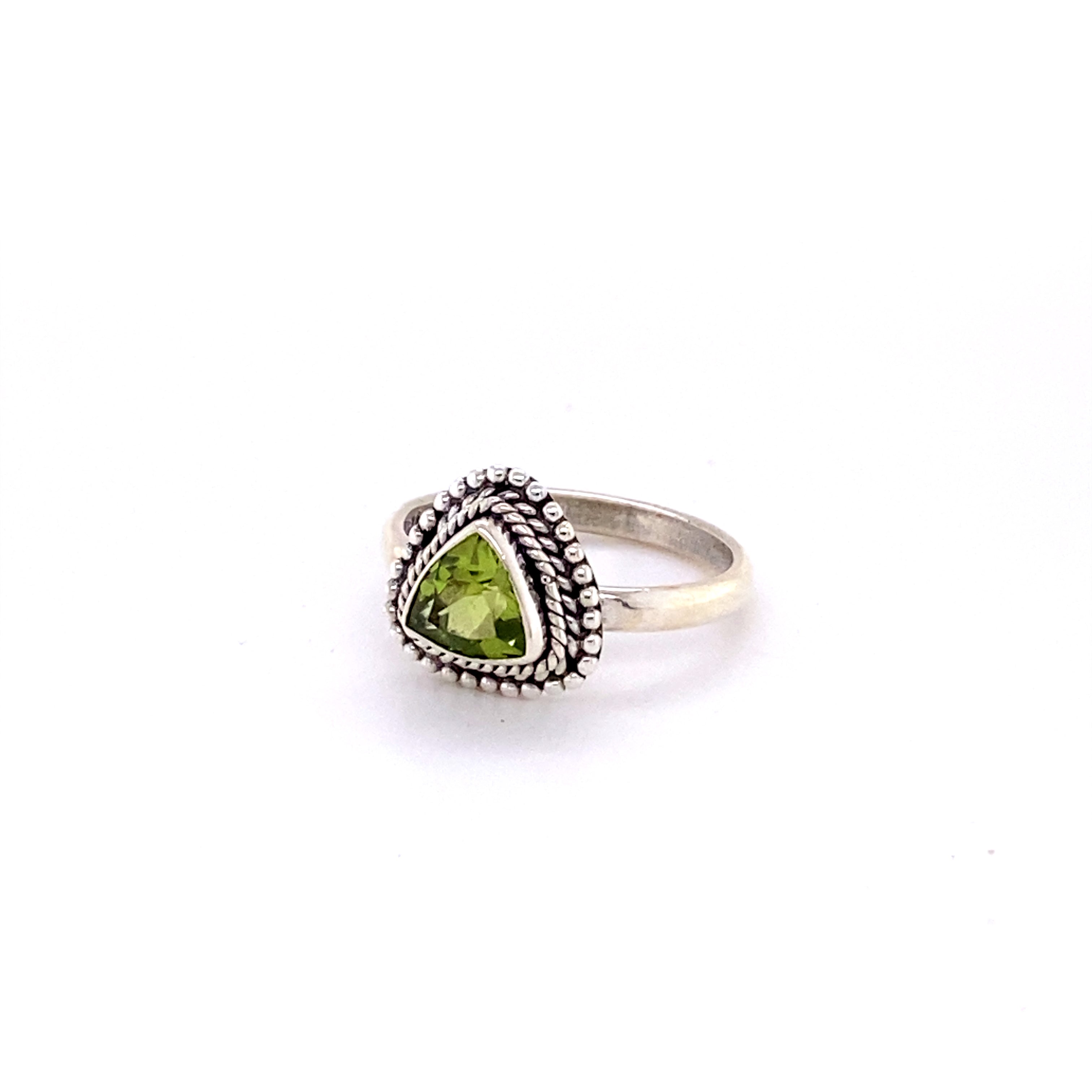 A boho-inspired Triangle Gemstone Ring with Rope Border with a peridot cabochon.