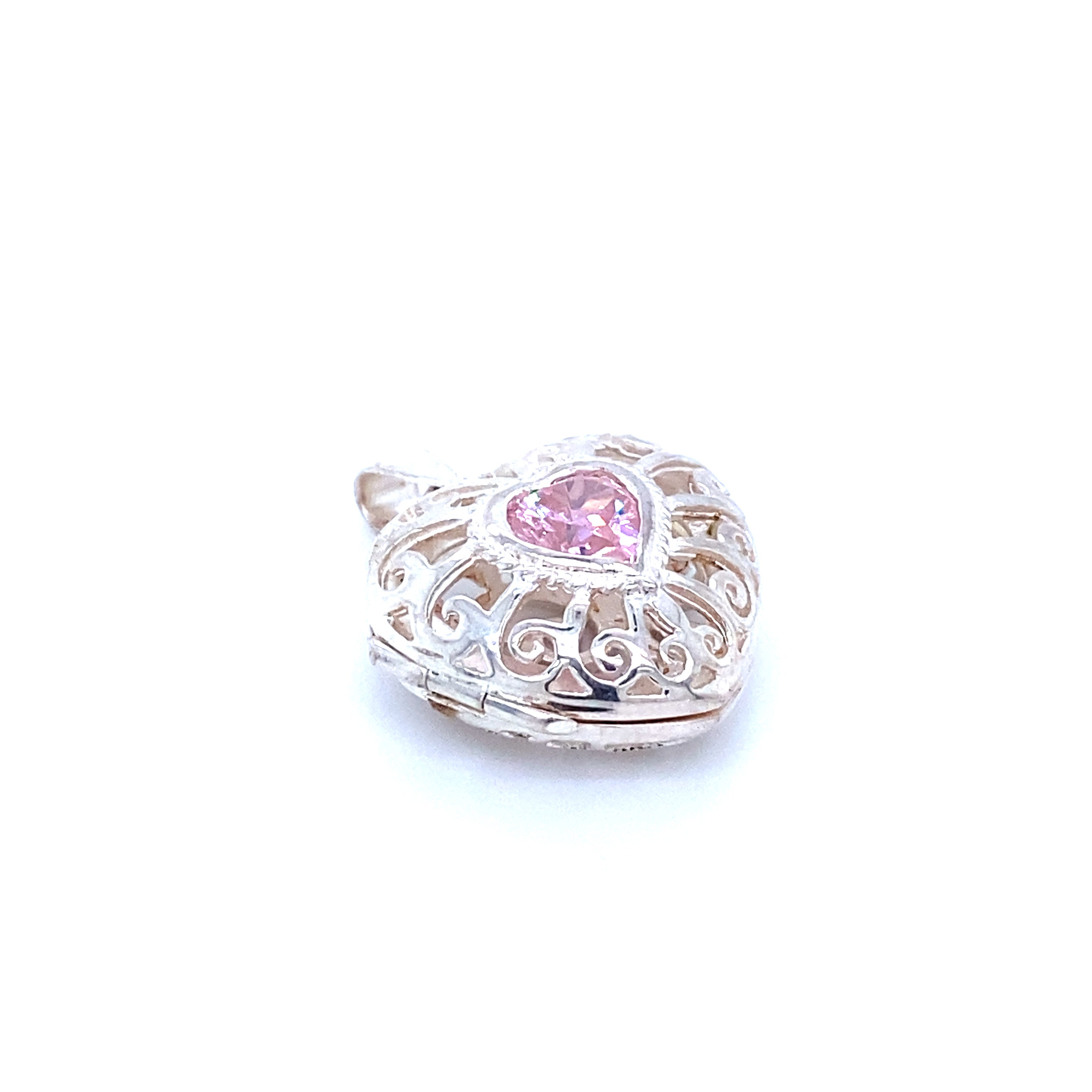 A Super Silver Heart Cage Locket With Cubic Zirconia Stones pendant with a filigree design and pink sapphires.