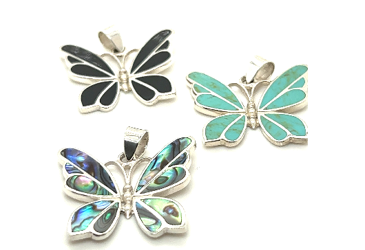 Three Medium Inlay Butterfly Pendants with different gemstone inlays—black, green, and iridescent blue. Each sterling silver pendant features a metallic outline and a loop for a necklace chain, making these exquisite pieces of gemstone jewelry truly enchanting.