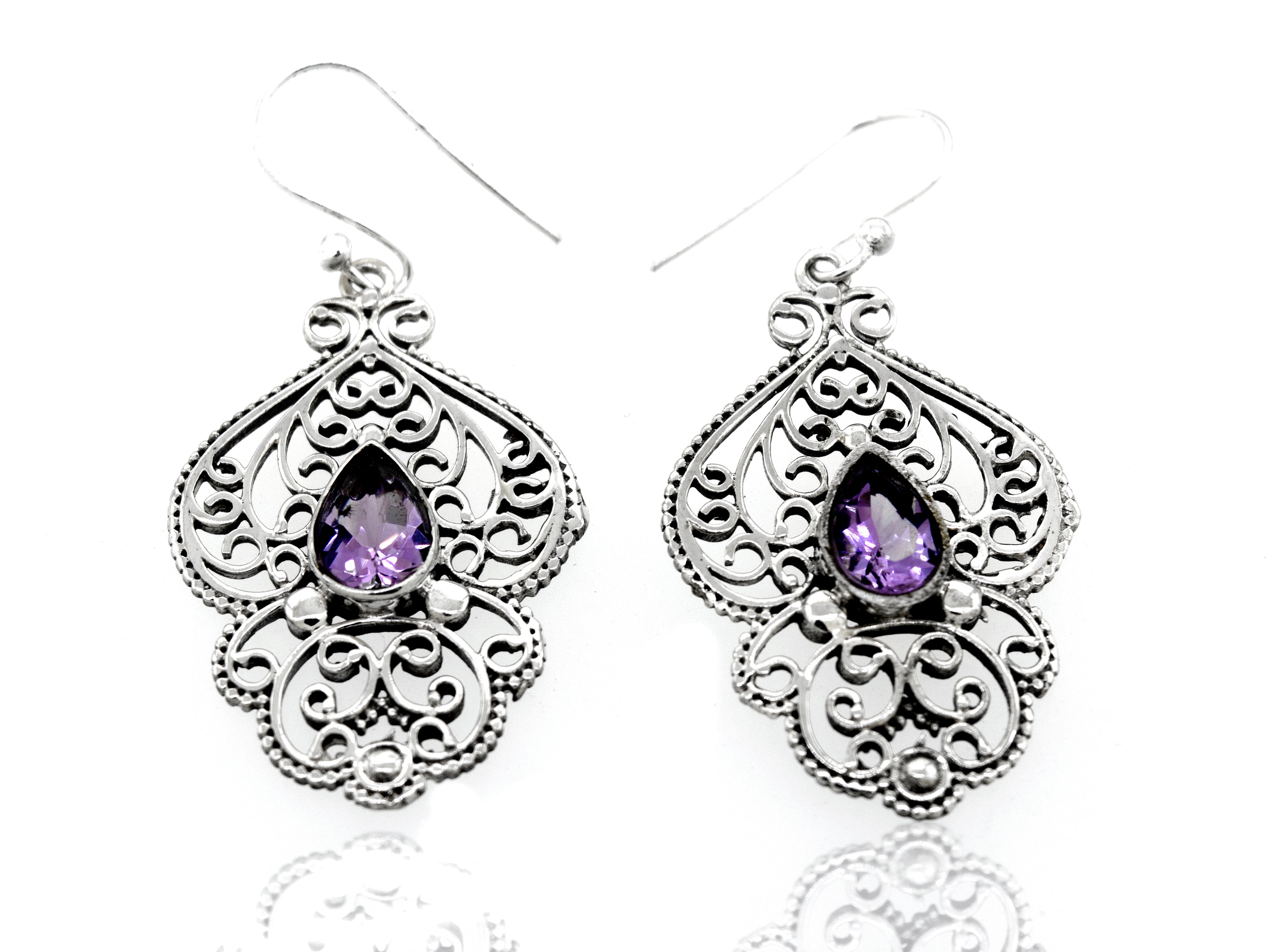 A pair of Super Silver Teardrop Amethyst Earrings with Freestyle Silver Design in a silver setting.