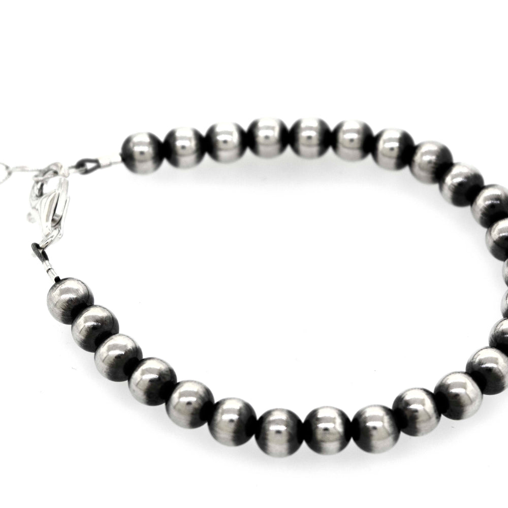 A Super Silver Handcrafted Navajo Pearl Bracelet with a vintage vibe on a white background.
