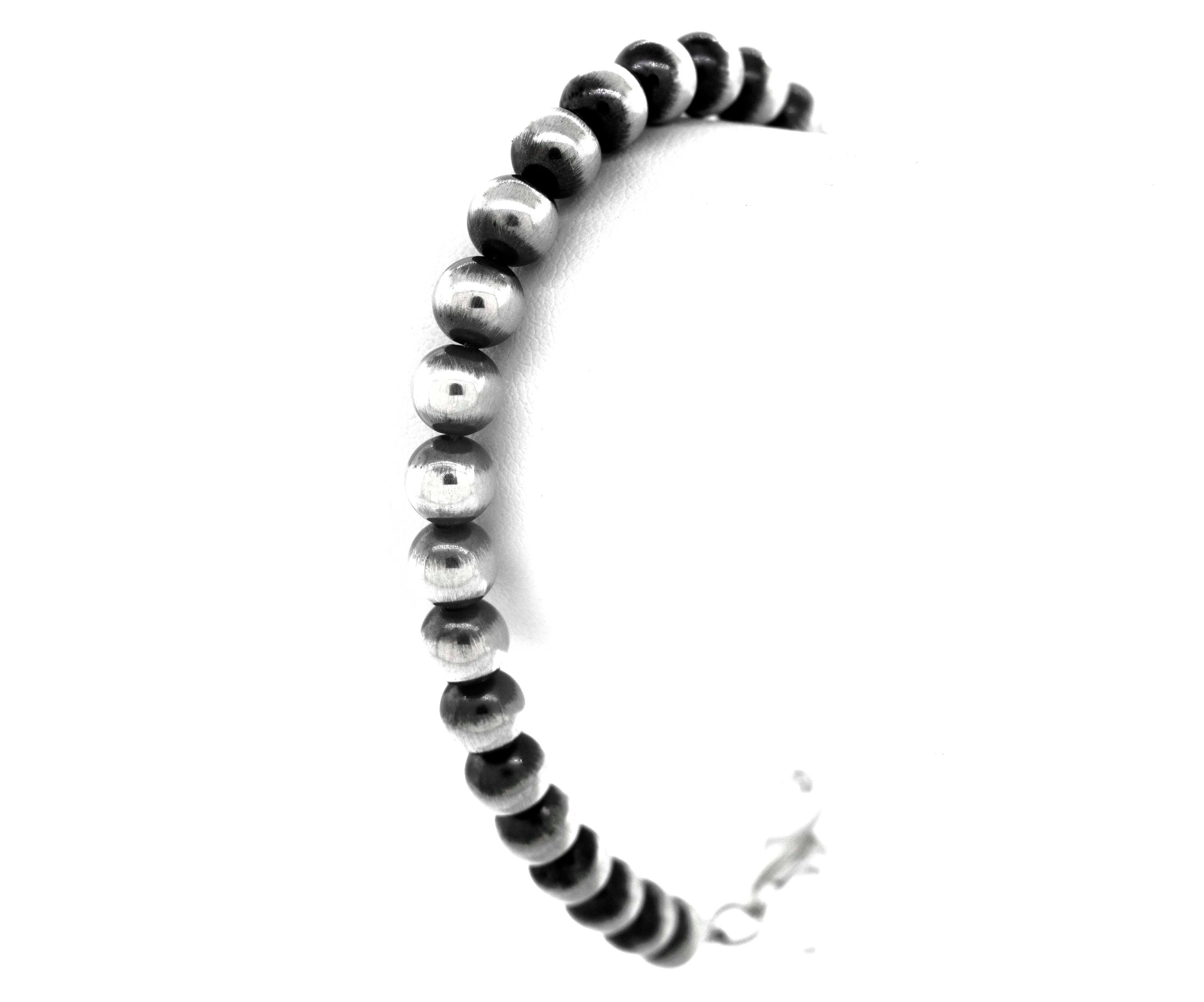 A Super Silver Handcrafted Navajo Pearl Bracelet with a vintage vibe, featuring elegant black and silver beads, displayed beautifully on a white background.