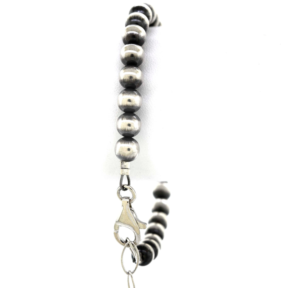 
                  
                    A Handcrafted Navajo Pearl Bracelet with black beads and a vintage vibe from Super Silver.
                  
                