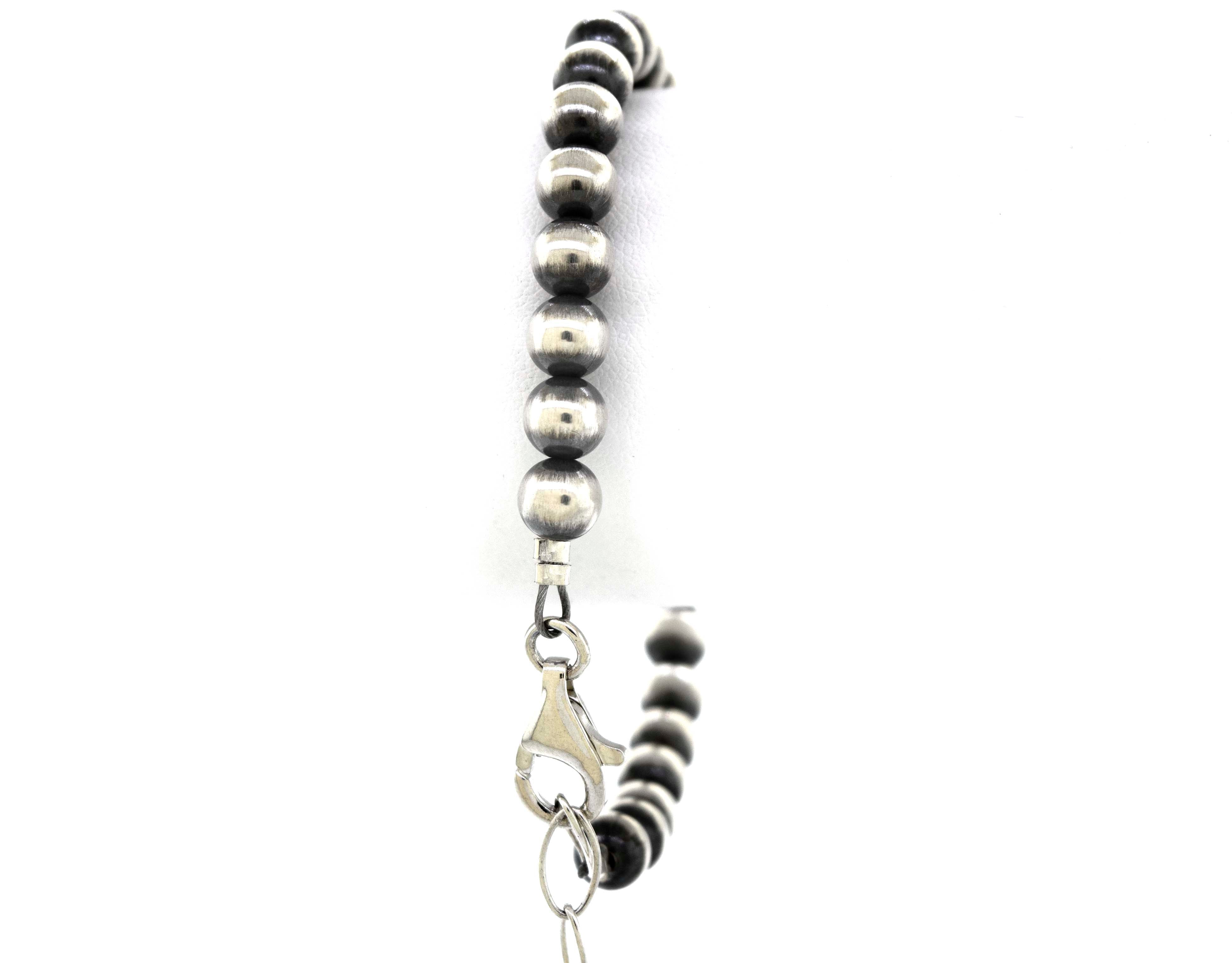 A Handcrafted Navajo Pearl Bracelet with black beads and a vintage vibe from Super Silver.