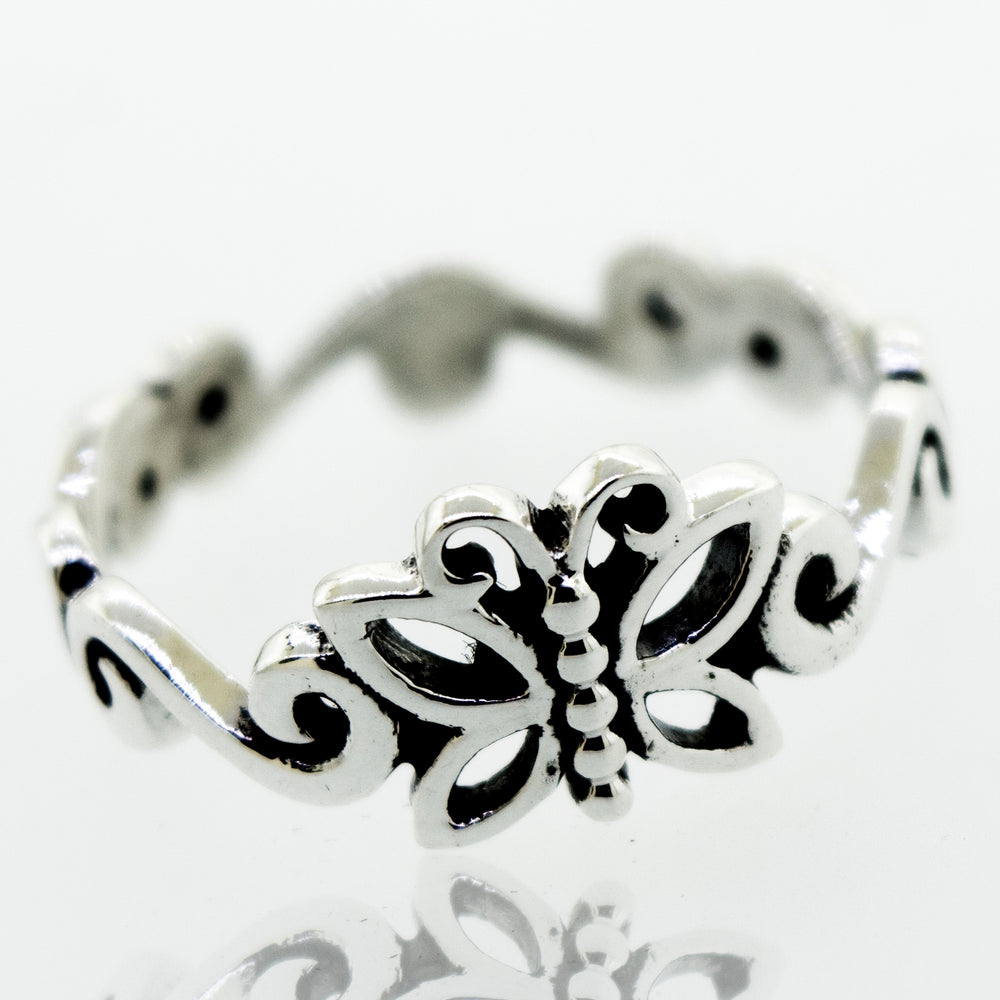 A Beautiful Butterfly Ring With Swirl Design Band with an intricate filigree design.