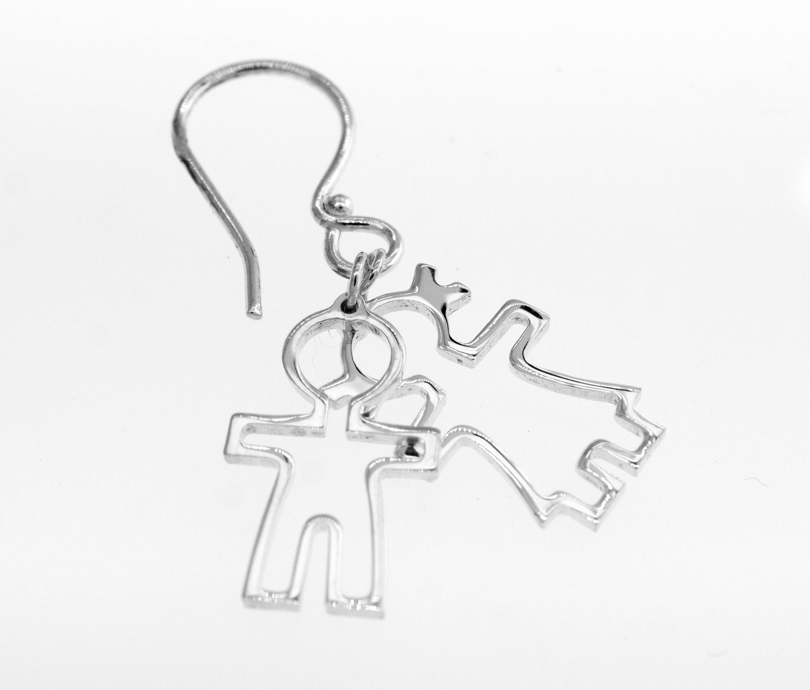A pair of Super Silver Little Humans Earrings featuring two people embracing.