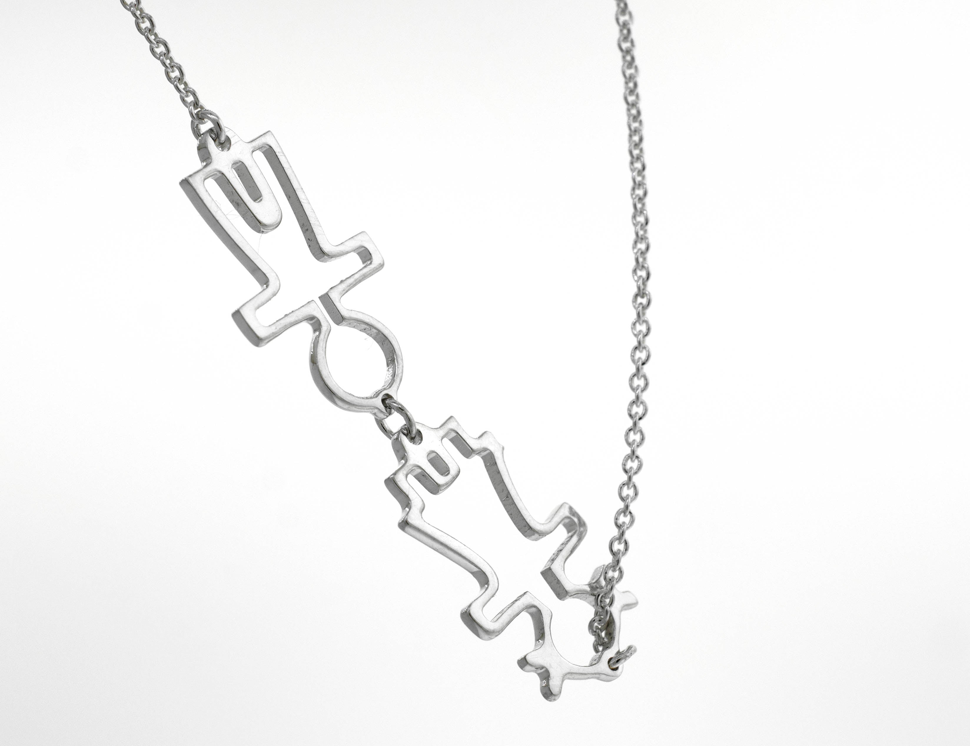 A Little Humans Necklace from Super Silver adorned with a pair of arrows, symbolizing love.