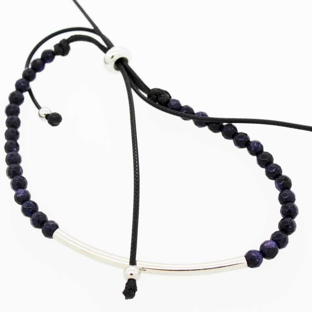 A versatile style adjustable gemstone bead bracelet featuring a silver bar and black beads by Super Silver.