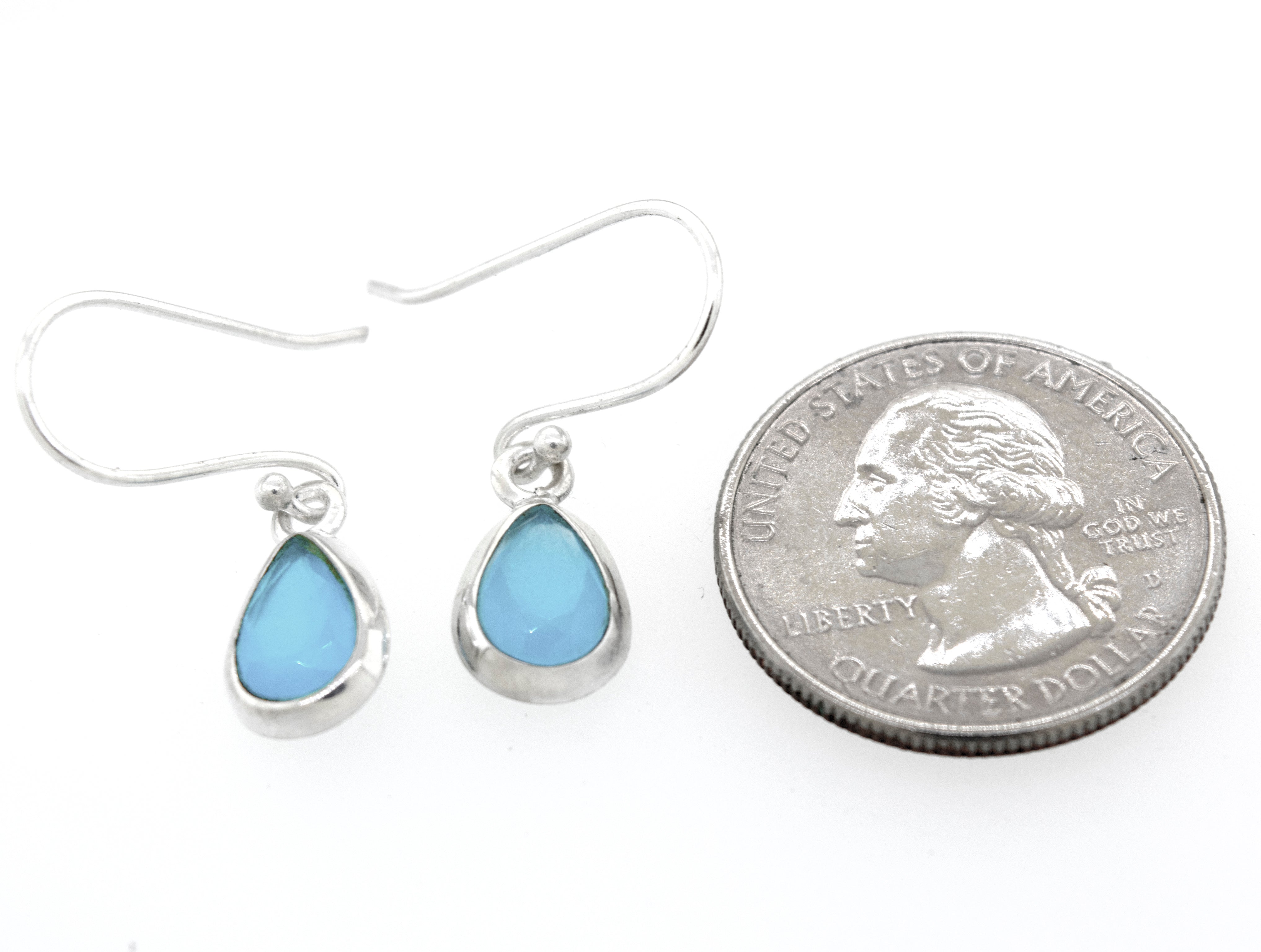A pair of Simple Teardrop Shape Blue Chalcedony Earrings by Super Silver with a blue opal stone in a sterling silver setting.