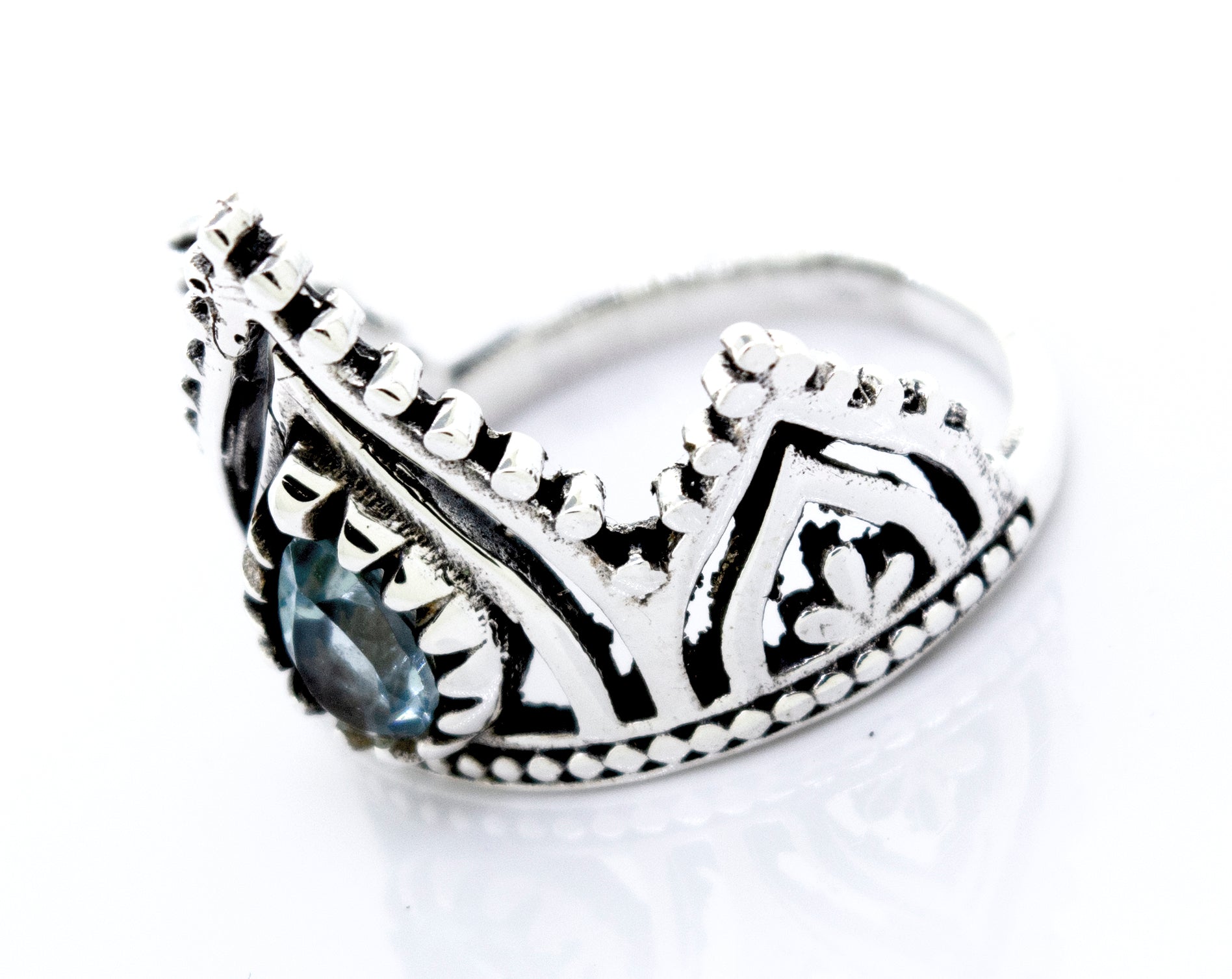 A Super Silver Crown Ring With Teardrop Shape Blue Topaz on it.