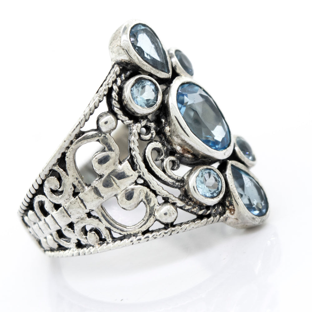 A Blue Topaz Ring With Freestyle Design by Super Silver, adorned with blue topaz stones.