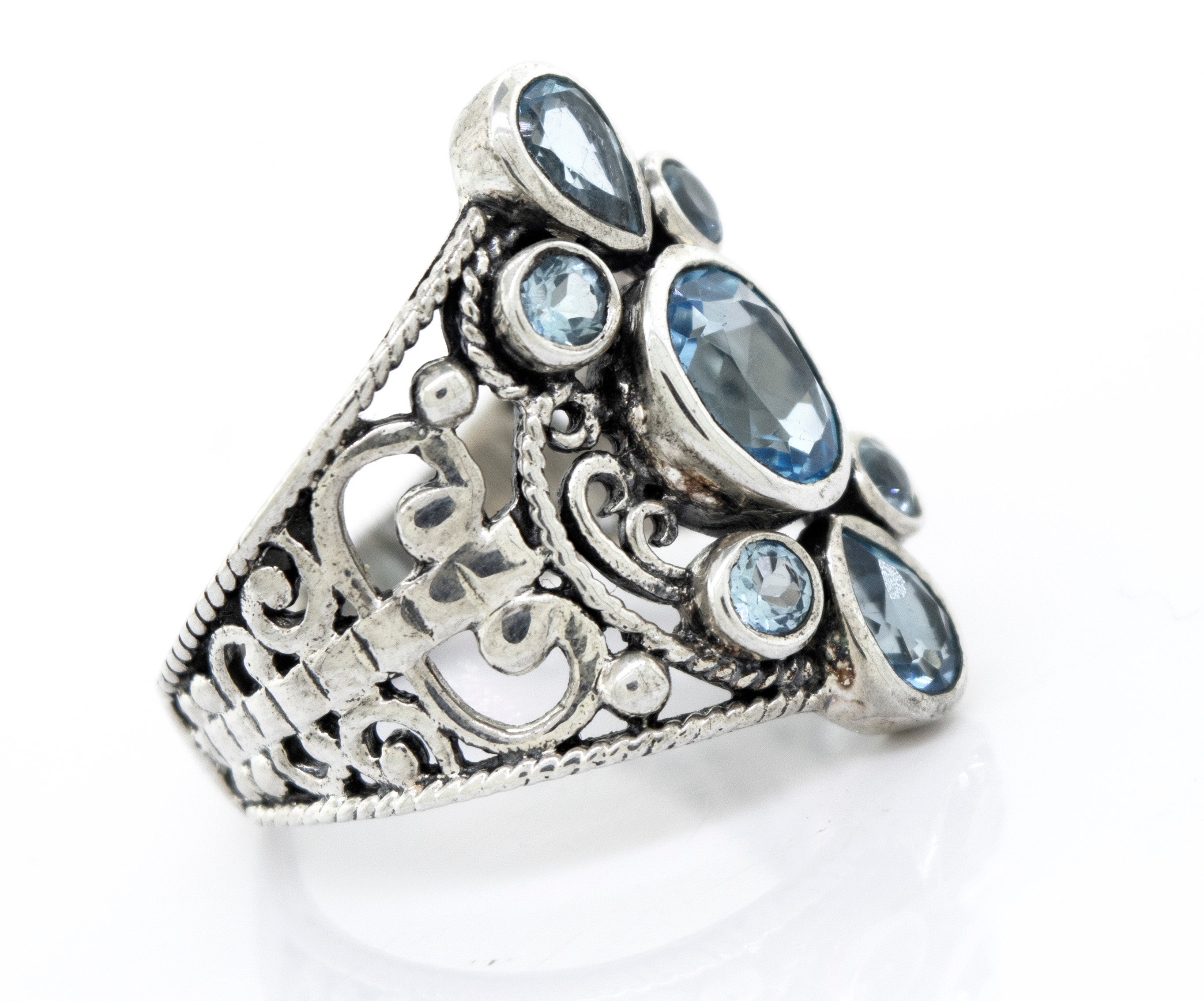 A Blue Topaz Ring With Freestyle Design by Super Silver, adorned with blue topaz stones.