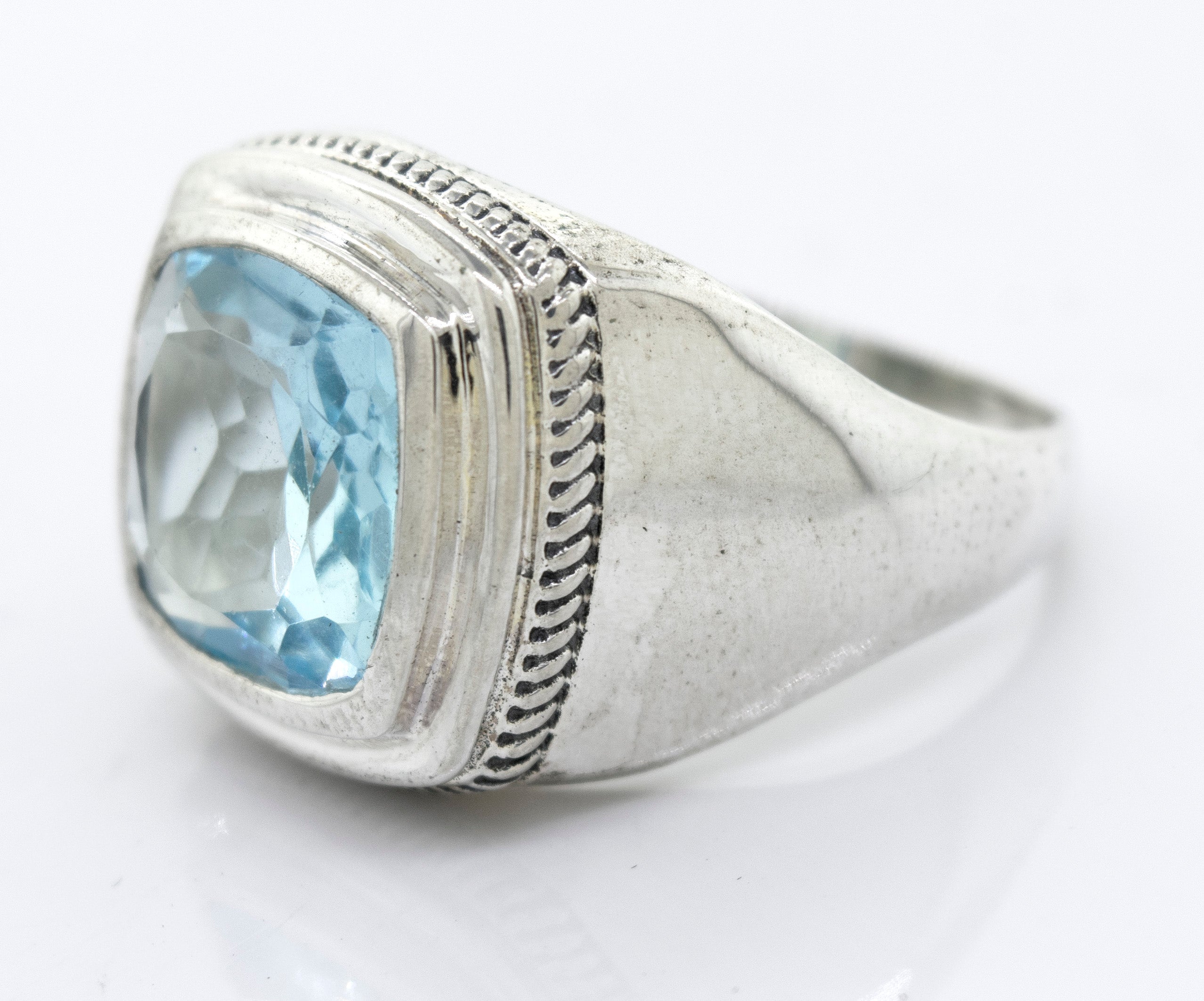 Faceted Stone Signet Ring with a square-cut light blue Blue Topaz gemstone in a pronged setting, displayed against a plain white background.