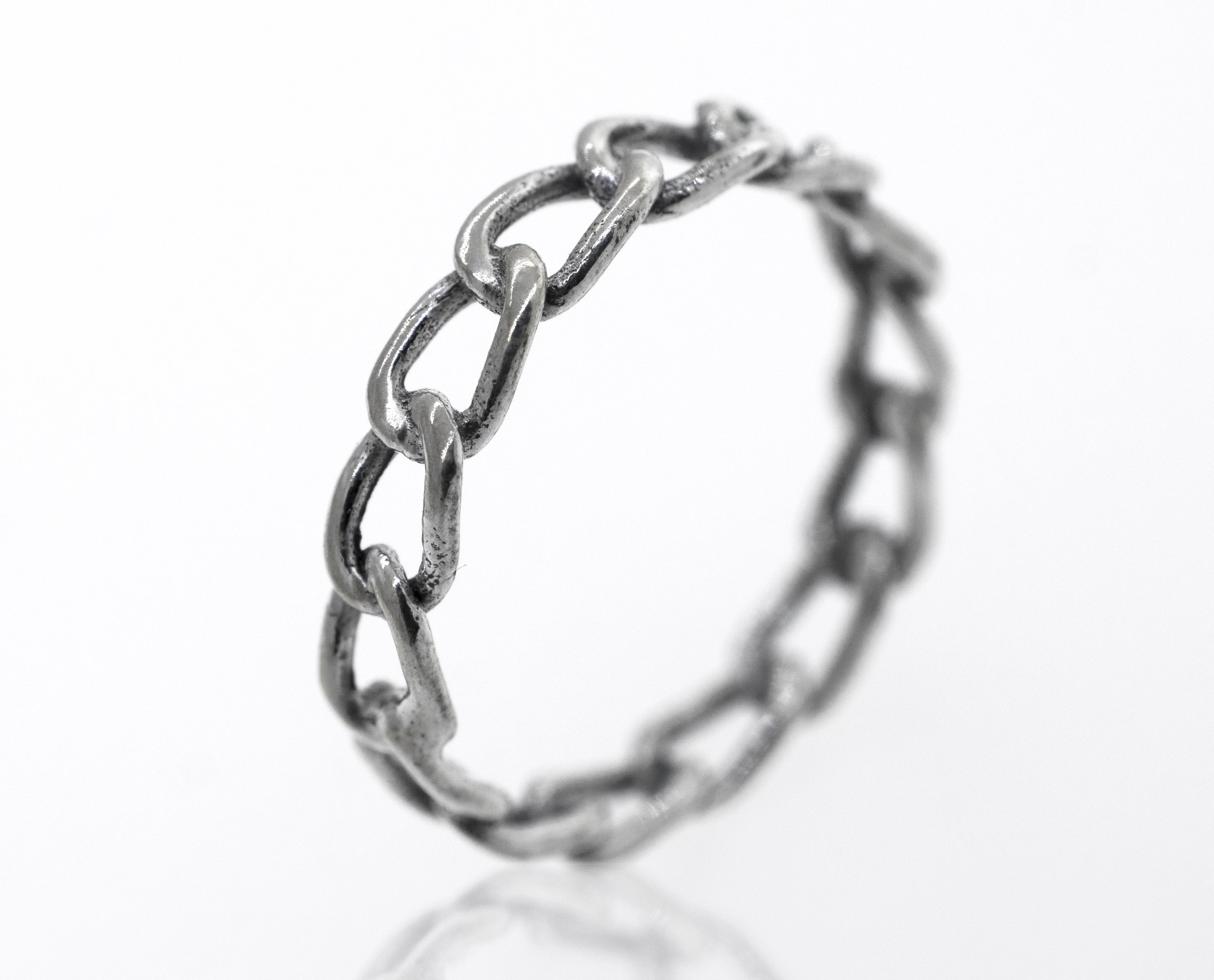 A Super Silver Chain Link Wire Ring on a white surface.