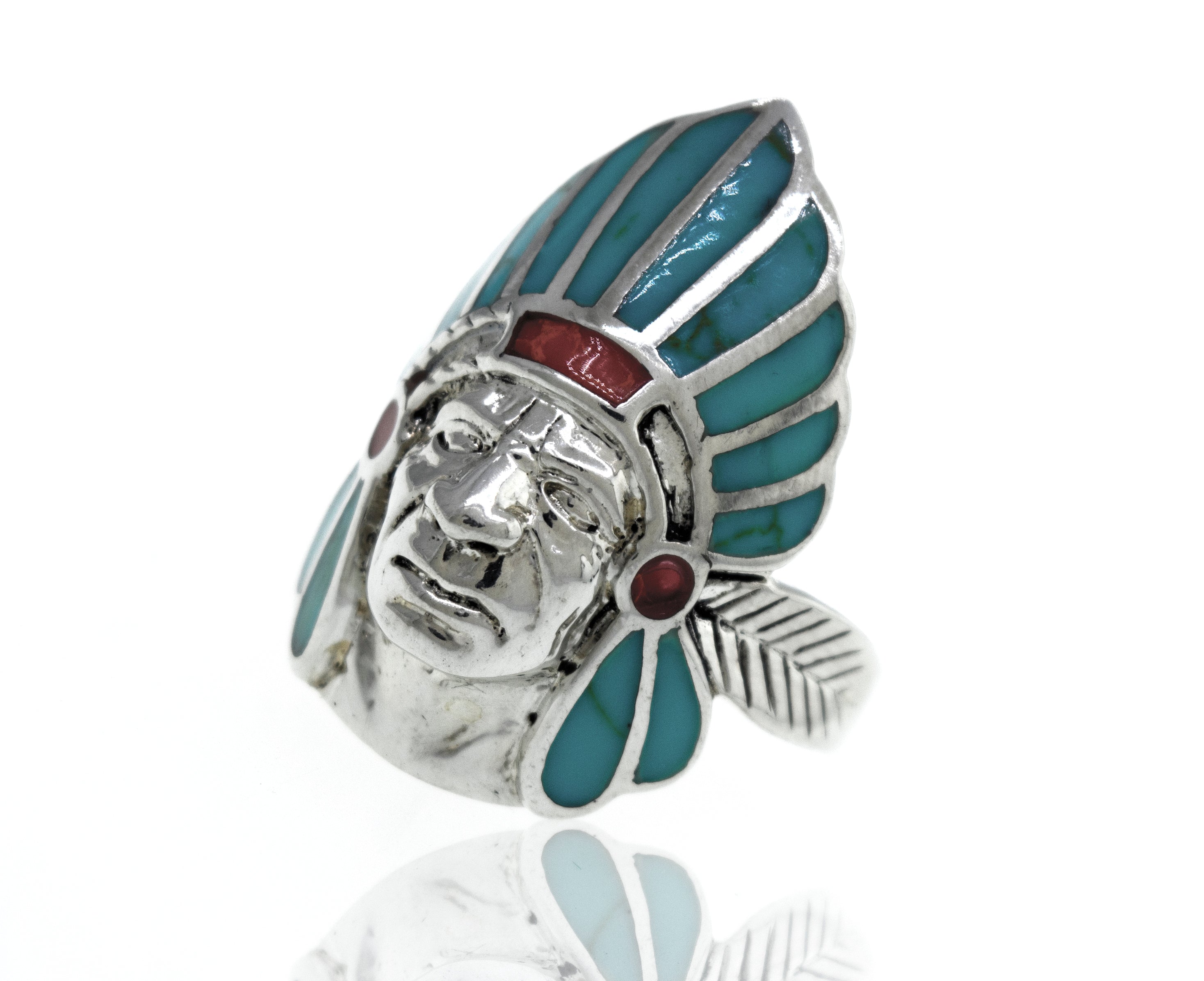 A sterling silver Turquoise And Coral Chief Head ring with turquoise and red stones.